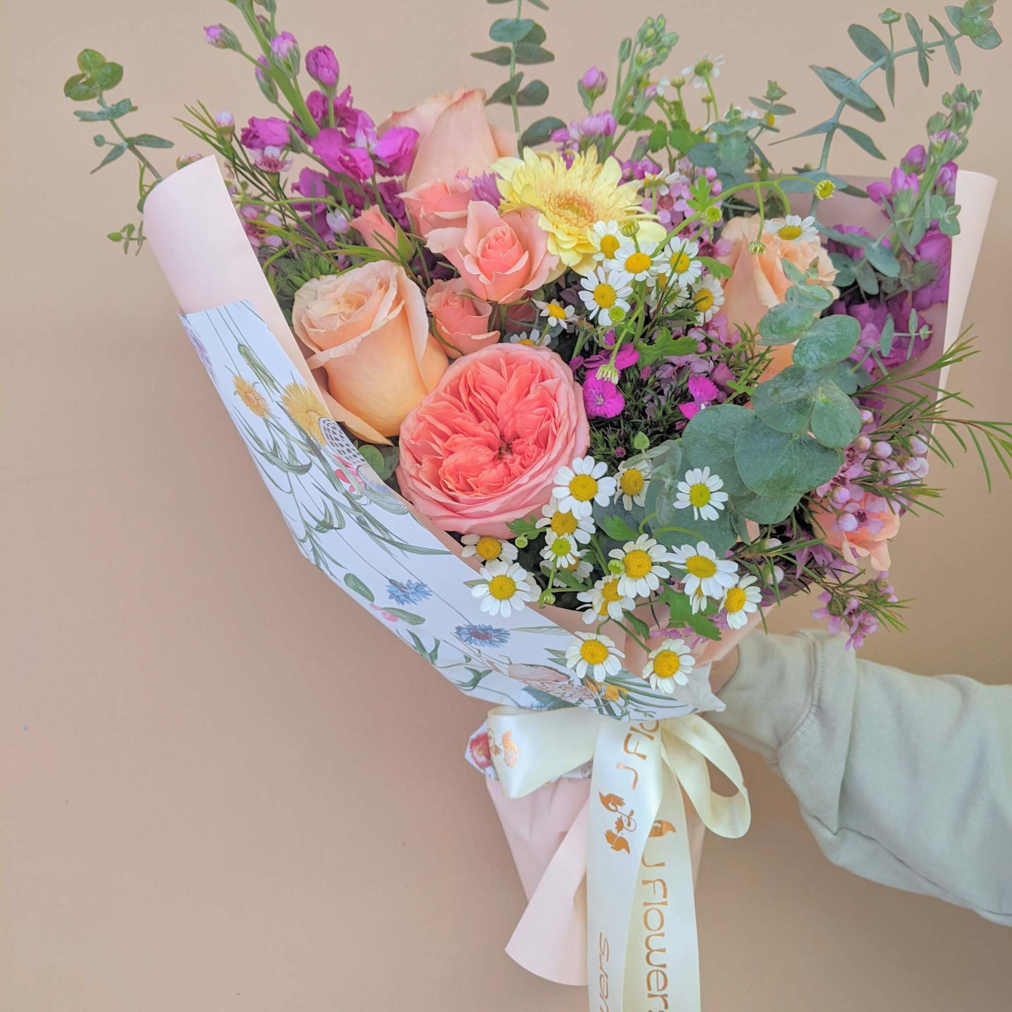This bouquet features a designer's choice of bright colors and a colorful This bouquet features a designer's choice of bright colors and a colorful