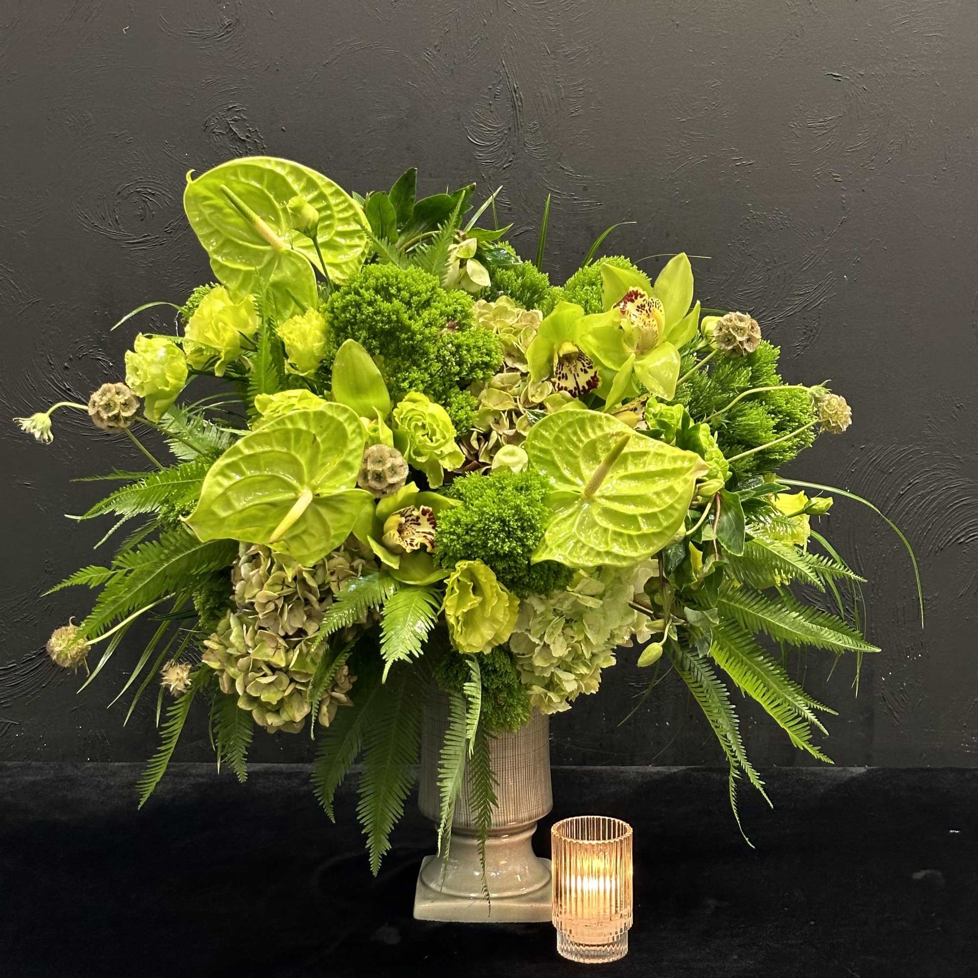 This striking arrangement features a vibrant mix of green flowers, creating a
