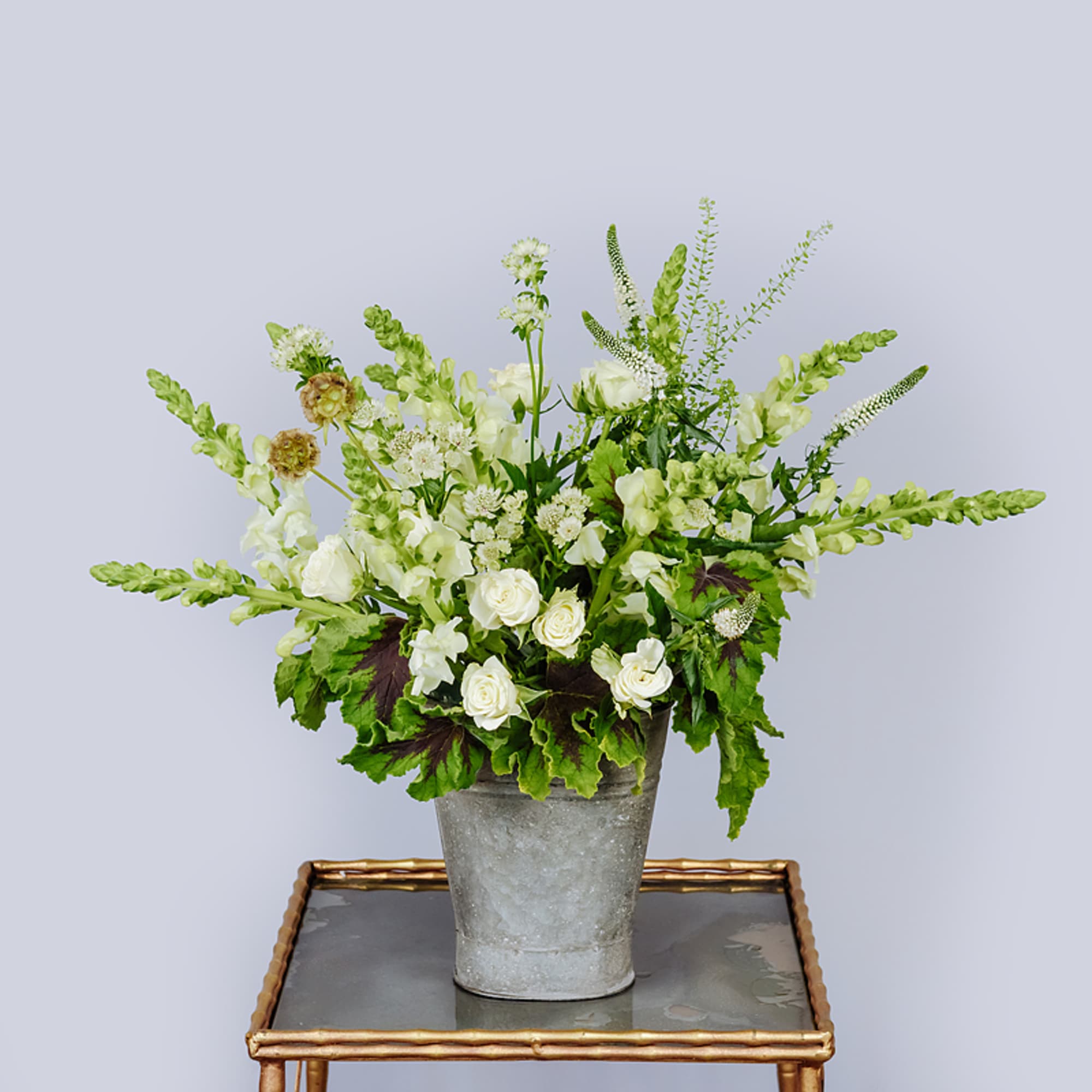 A bucket full of sweet white and green floral, our kind of