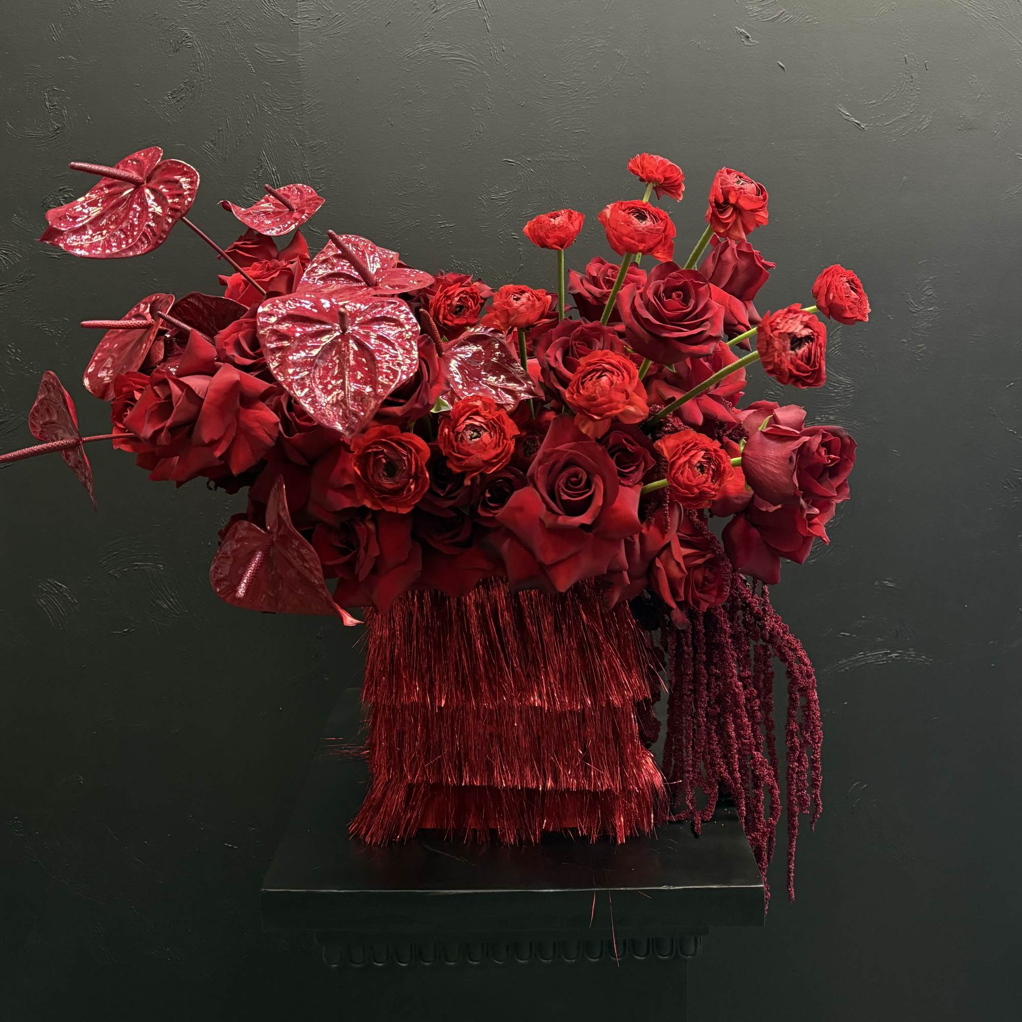 This all-red arrangement is a bold and captivating display, featuring rich, velvety