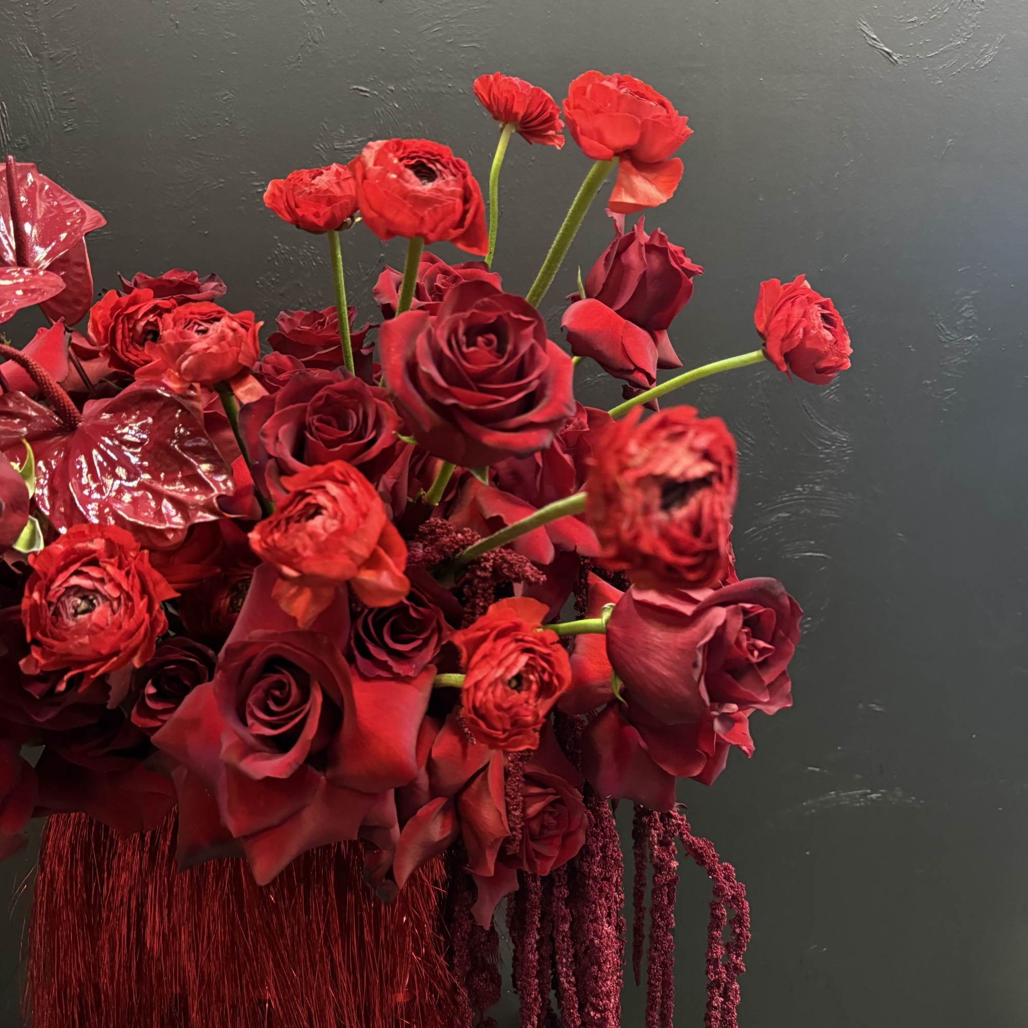 This all-red arrangement is a bold and captivating display, featuring rich, velvety
