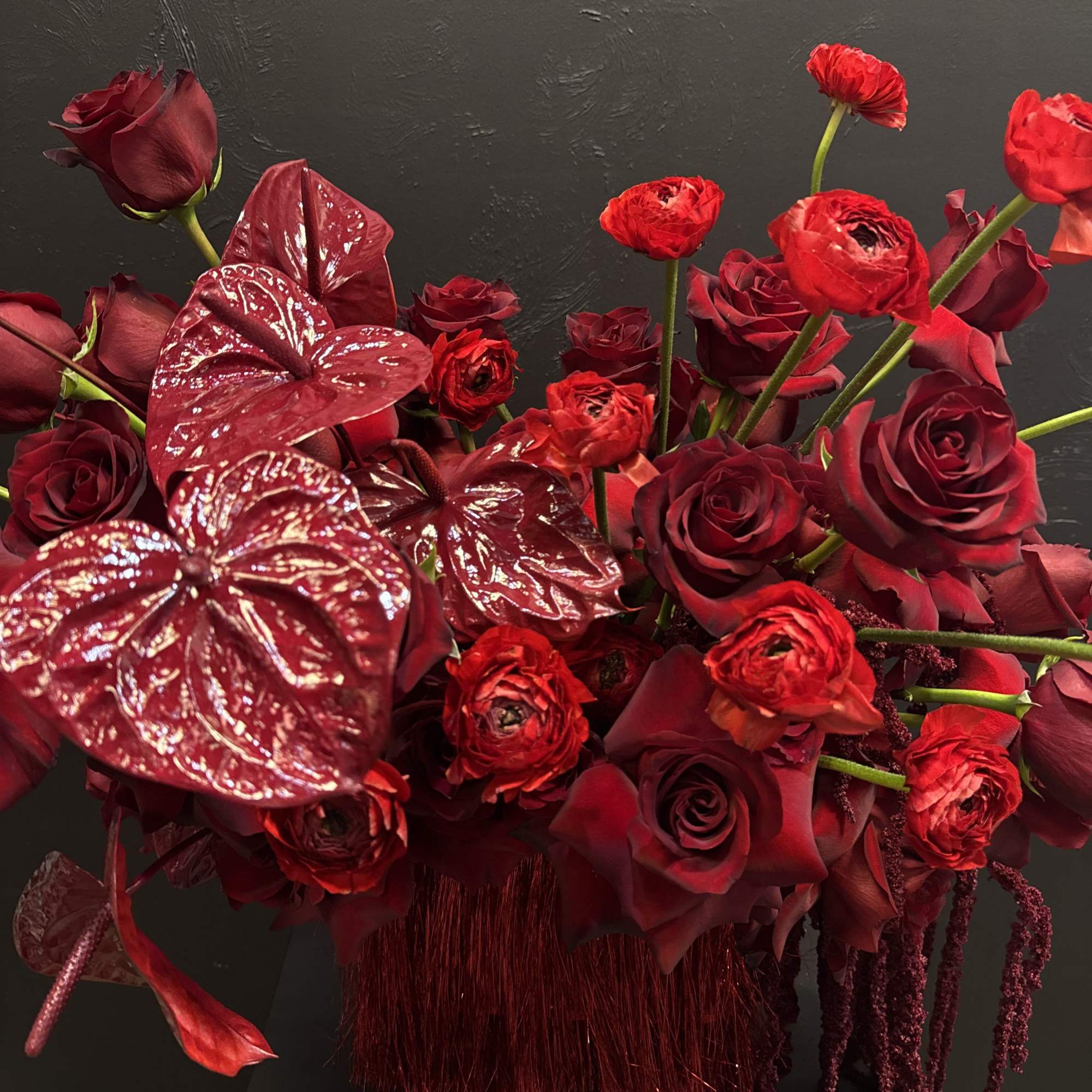This all-red arrangement is a bold and captivating display, featuring rich, velvety