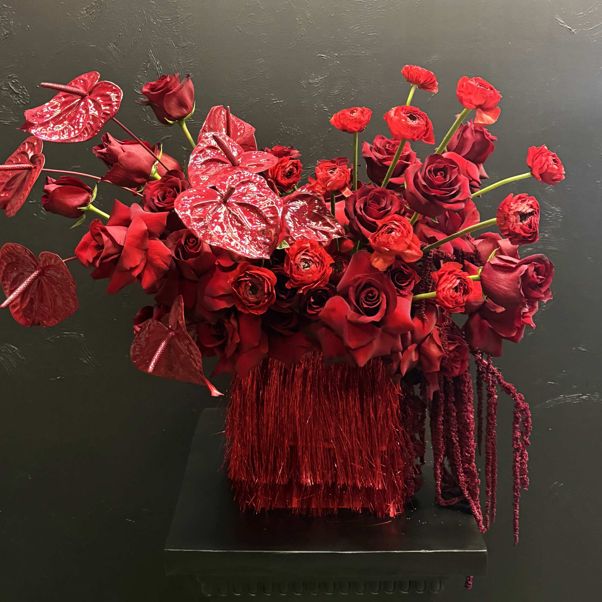 This all-red arrangement is a bold and captivating display, featuring rich, velvety