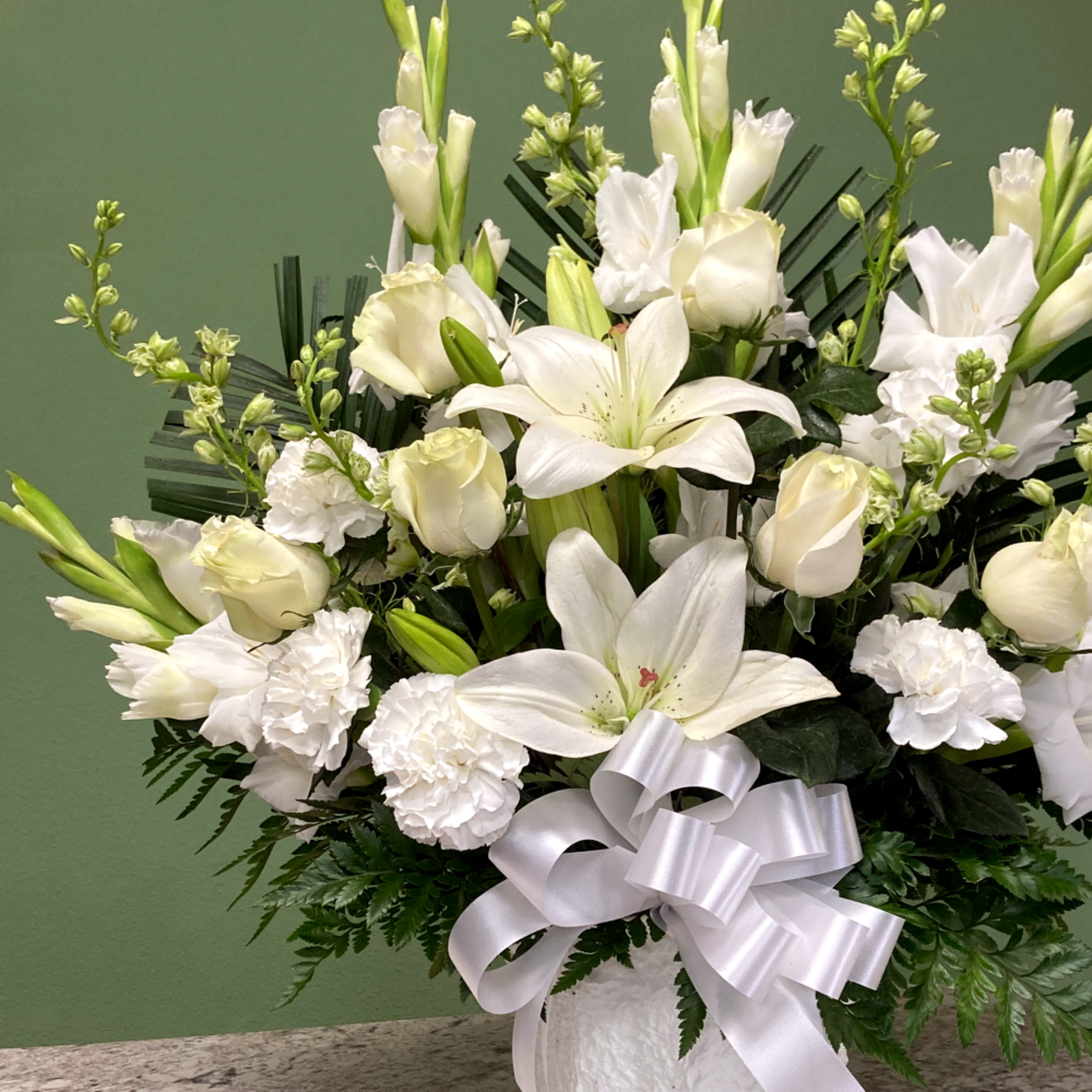 A touching papier m&acirc;ch&eacute; basket arrangement thoughtfully designed to honor and celebrate