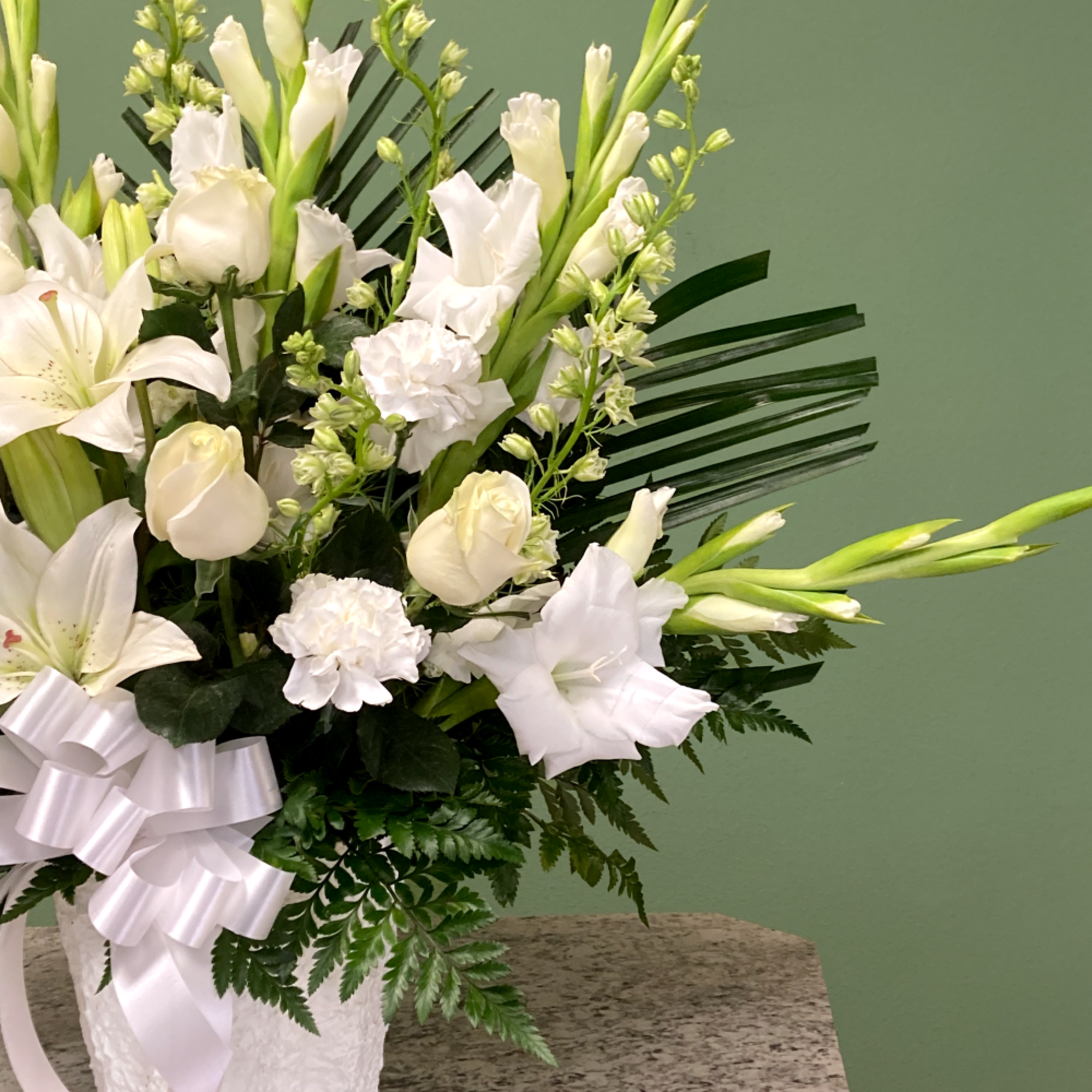 A touching papier m&acirc;ch&eacute; basket arrangement thoughtfully designed to honor and celebrate