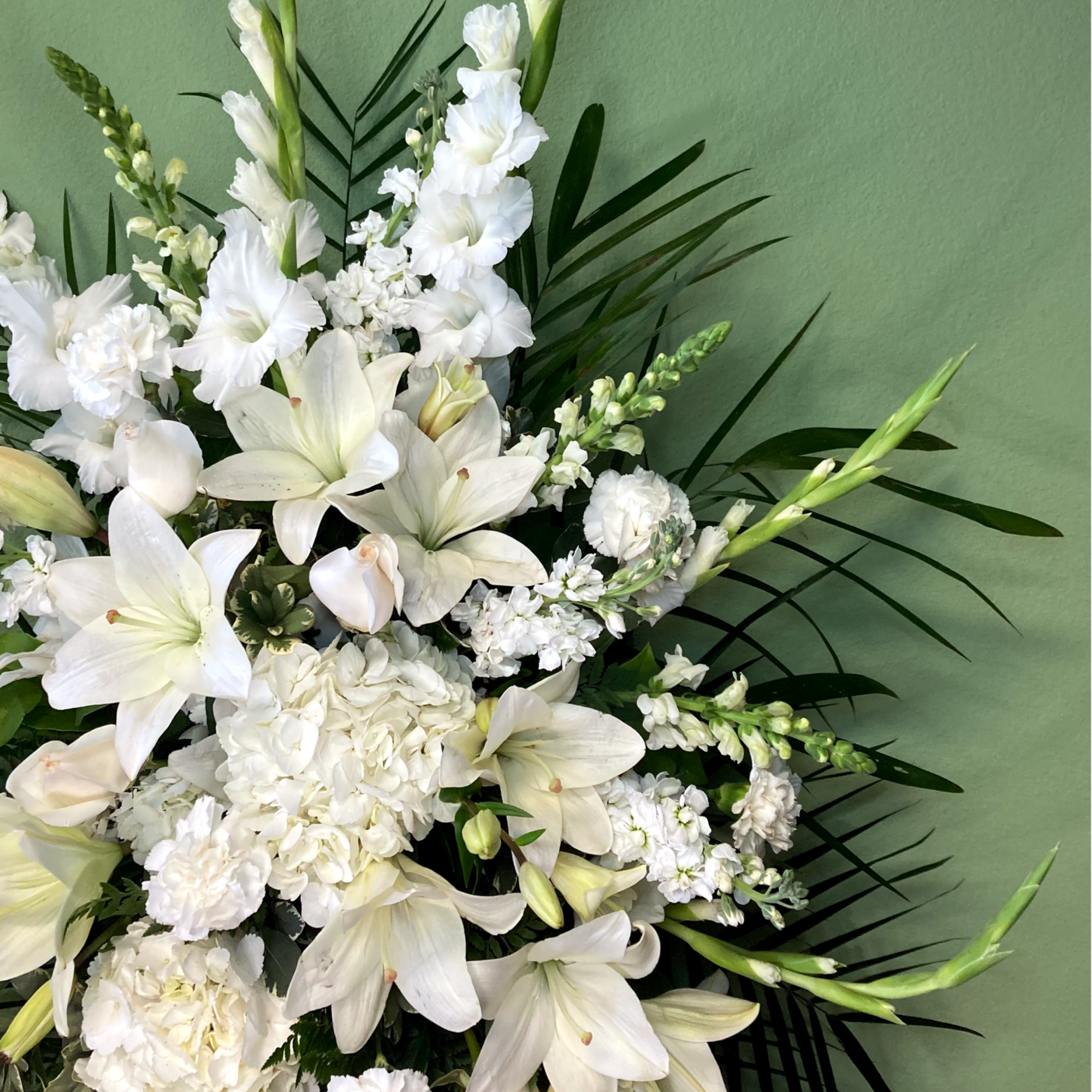 A serene standing spray of flowers that arrives delivered on an easel