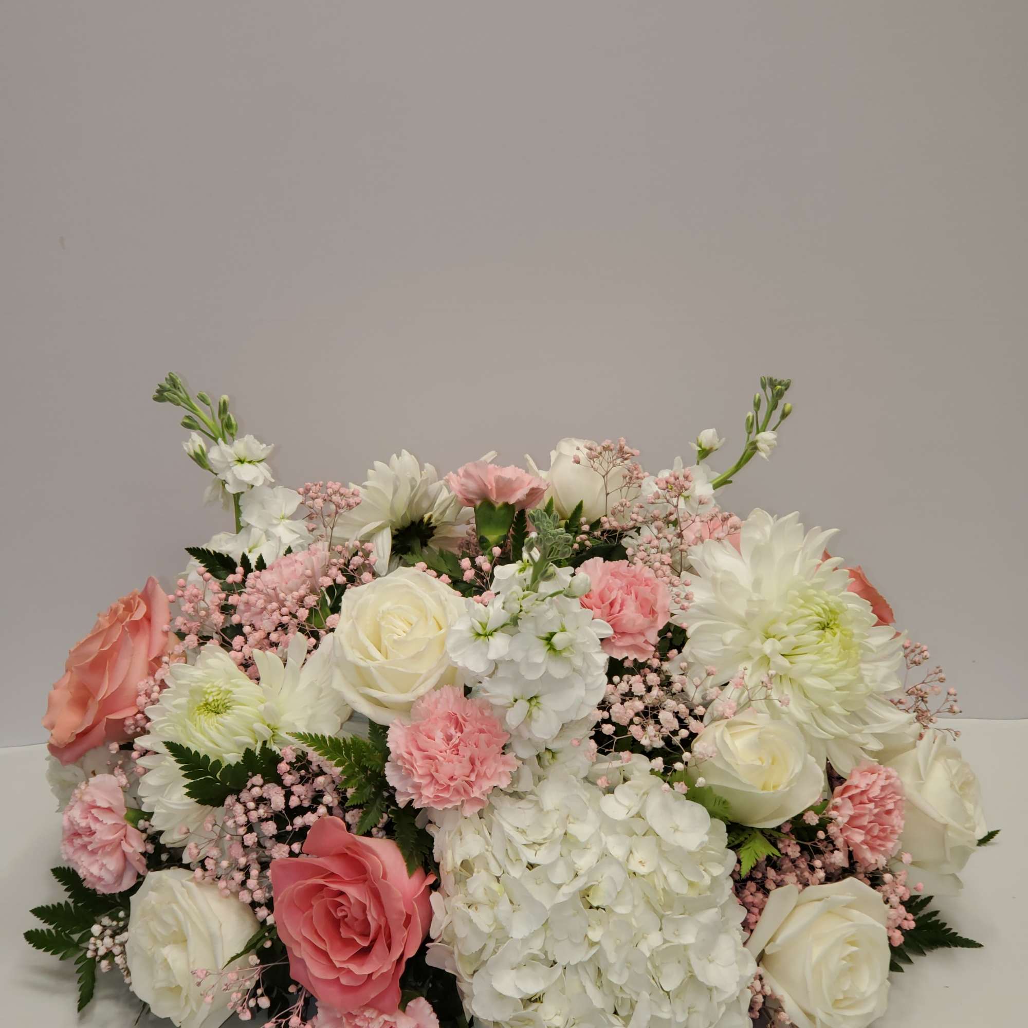 12 roses, 12 carnations, 3 hydrangea, 3 white stock and  3