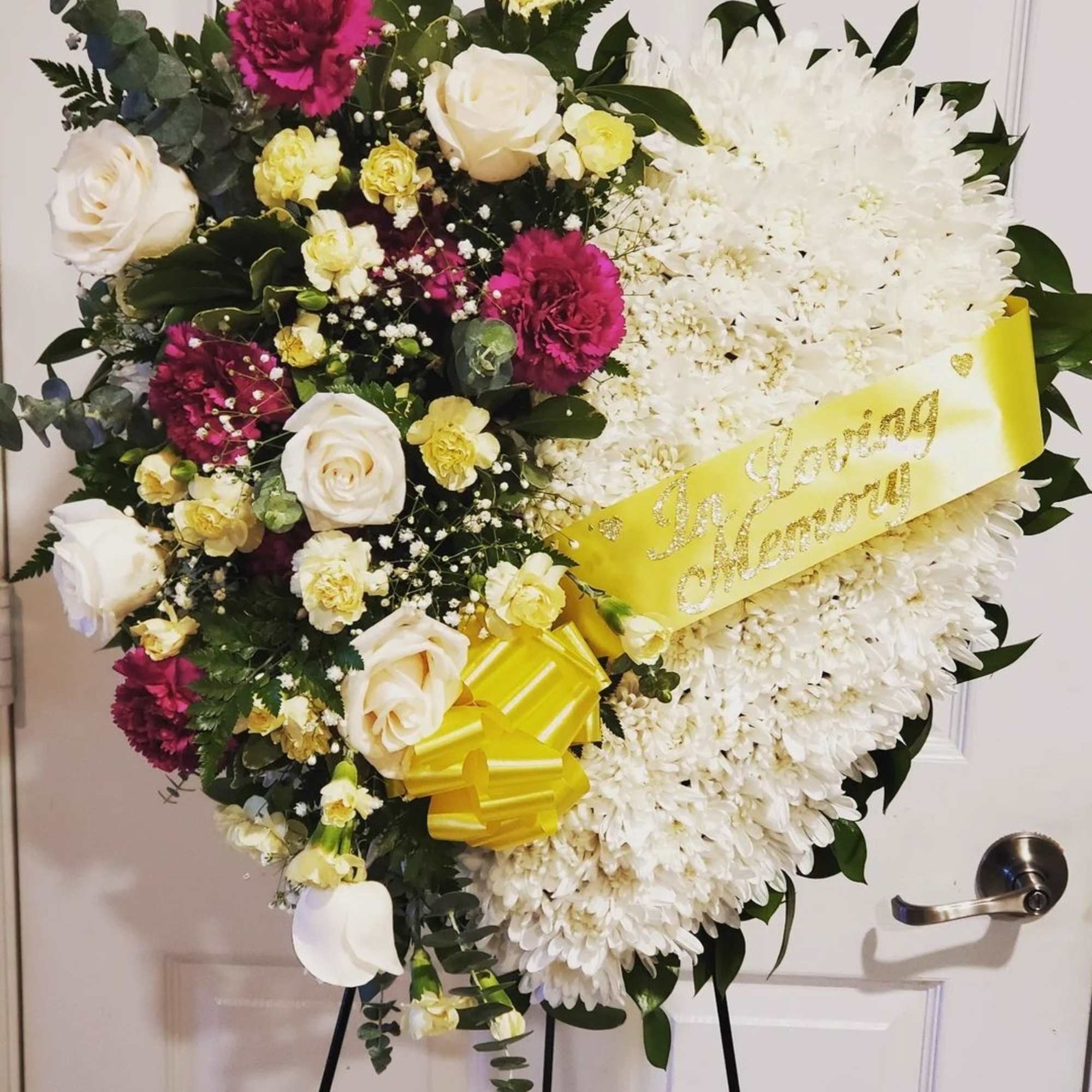 In Loving Memory of........Featuring a variety of white flowers, red carnation, white