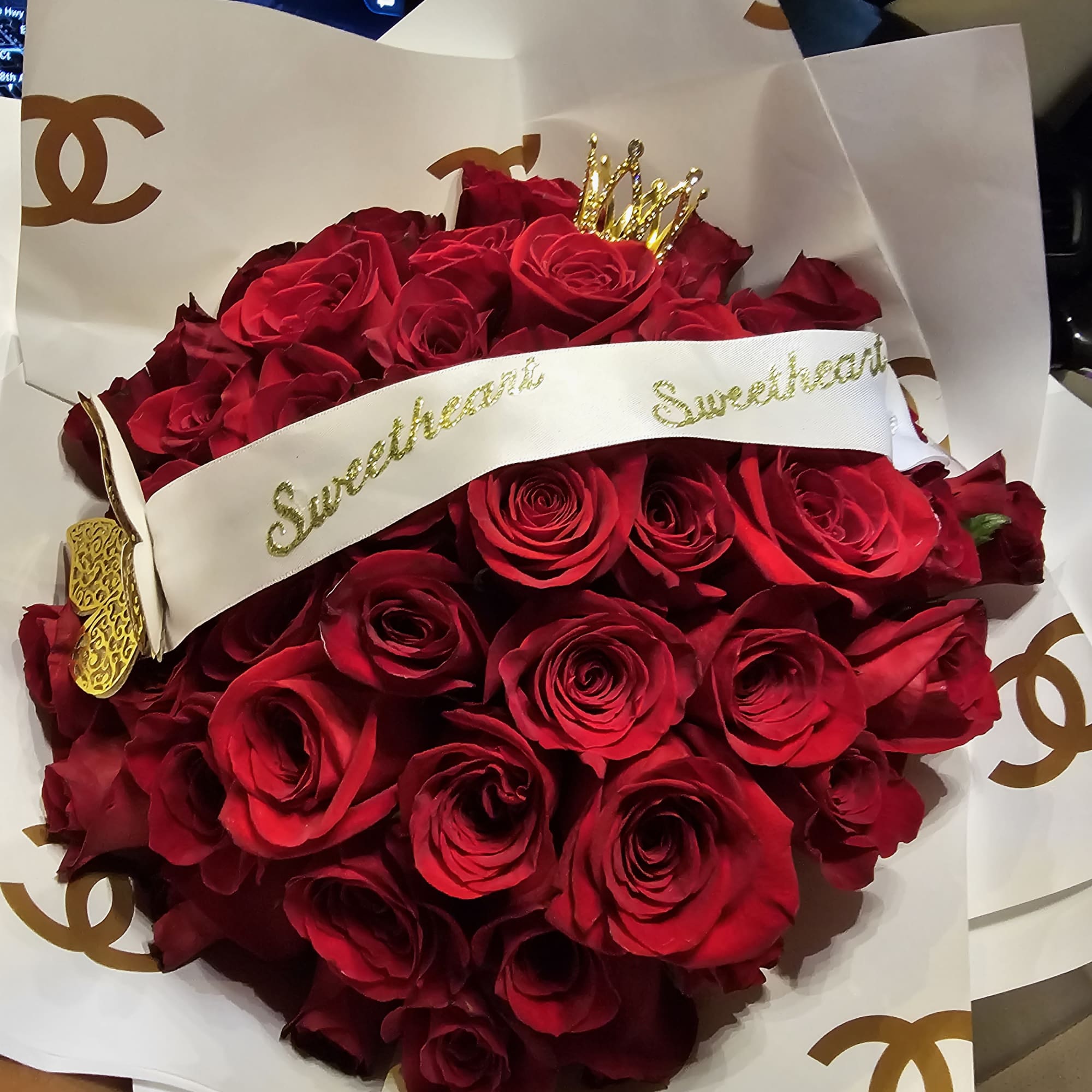 Fresh hand-tied roses wrapped with luxury floral papers accented with diamonds, butterflies