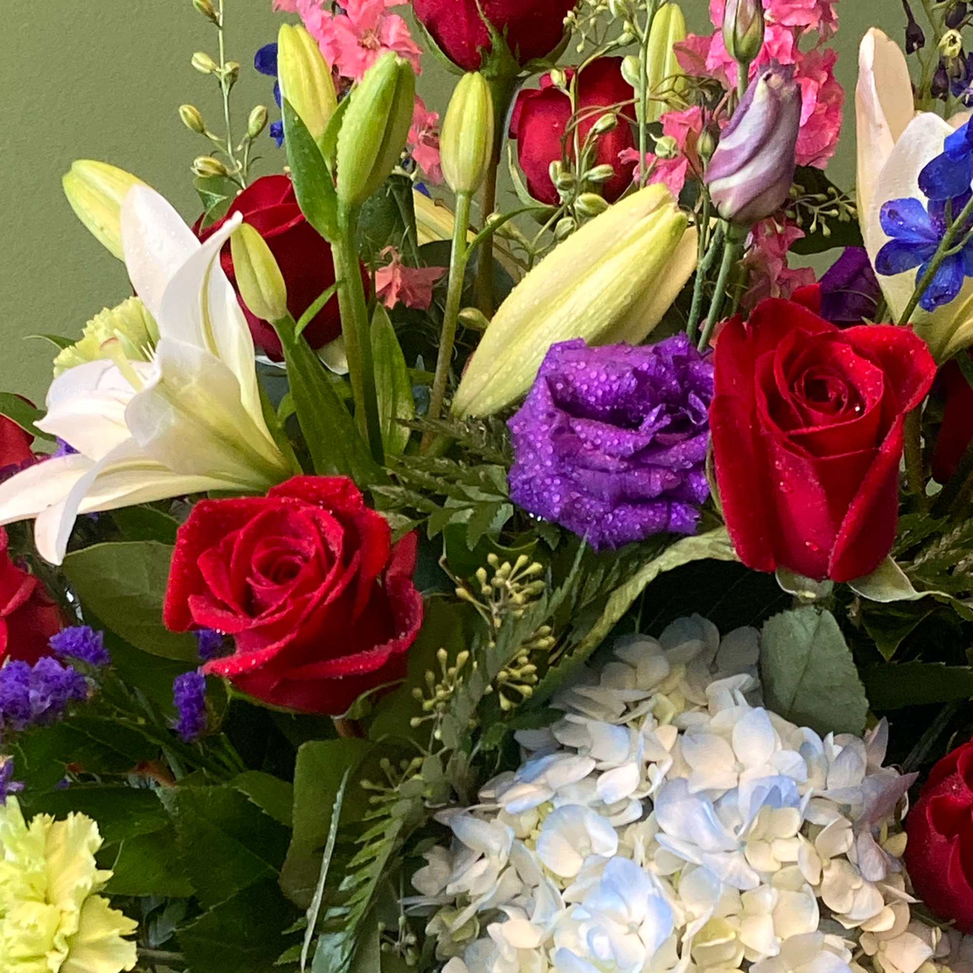 A beautiful arrangement, featuring one dozen (12) premium red roses, blended with