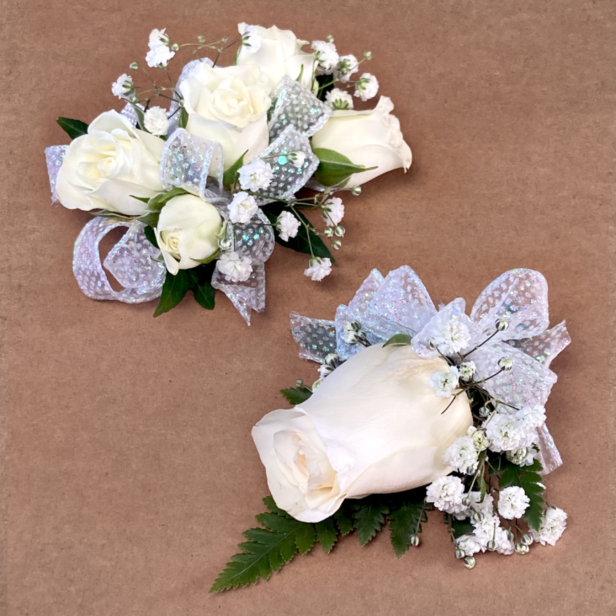 Custom wristlet corsage and boutonni&egrave;re that feature the same rose color, accented