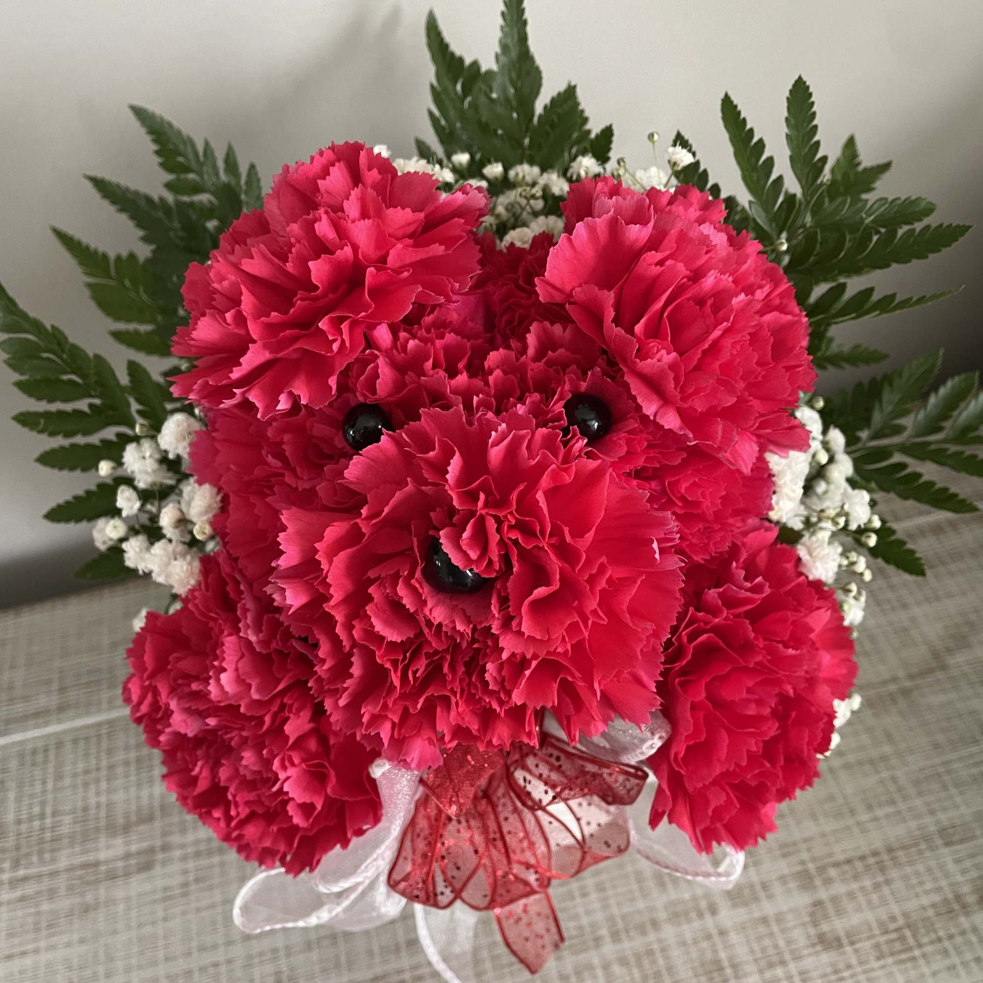This cute carnation arrangement is sure to bring joy to the recipient!