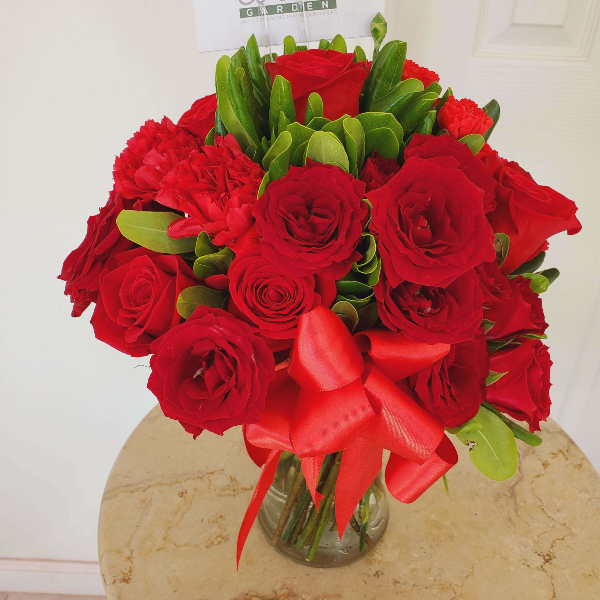 Crystal vase arrangement with a radiant assortment of 12 red roses, 10