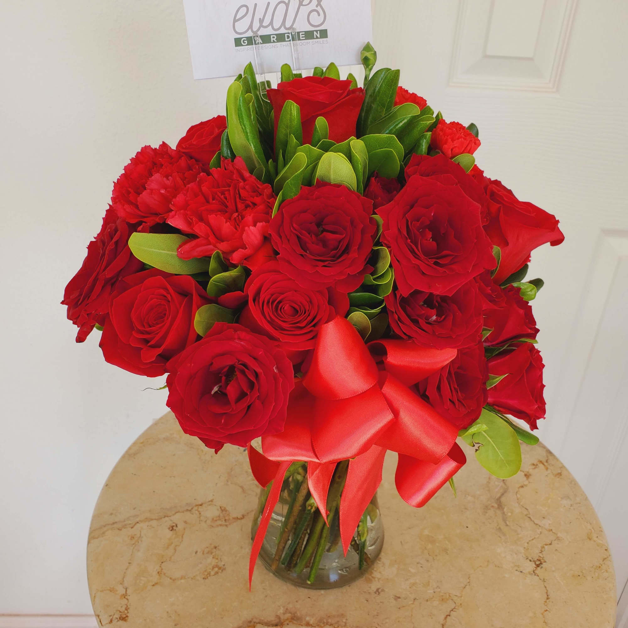 Crystal vase arrangement with a radiant assortment of 12 red roses, 10