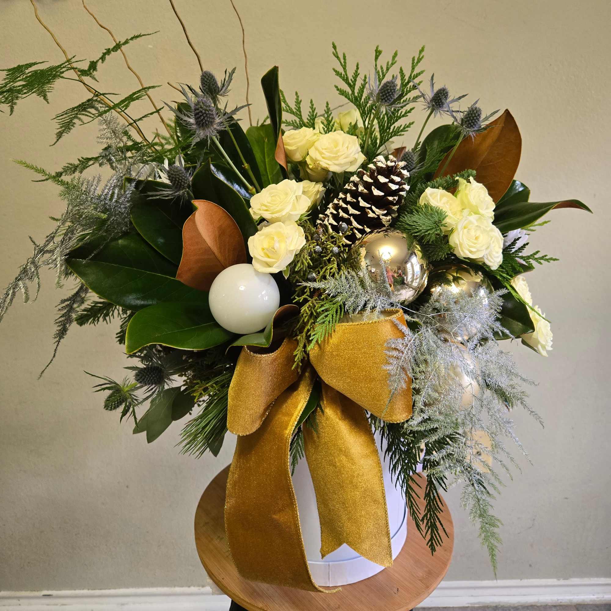 This is a beautiful white hat box arrangement with white roses, eucalyptus