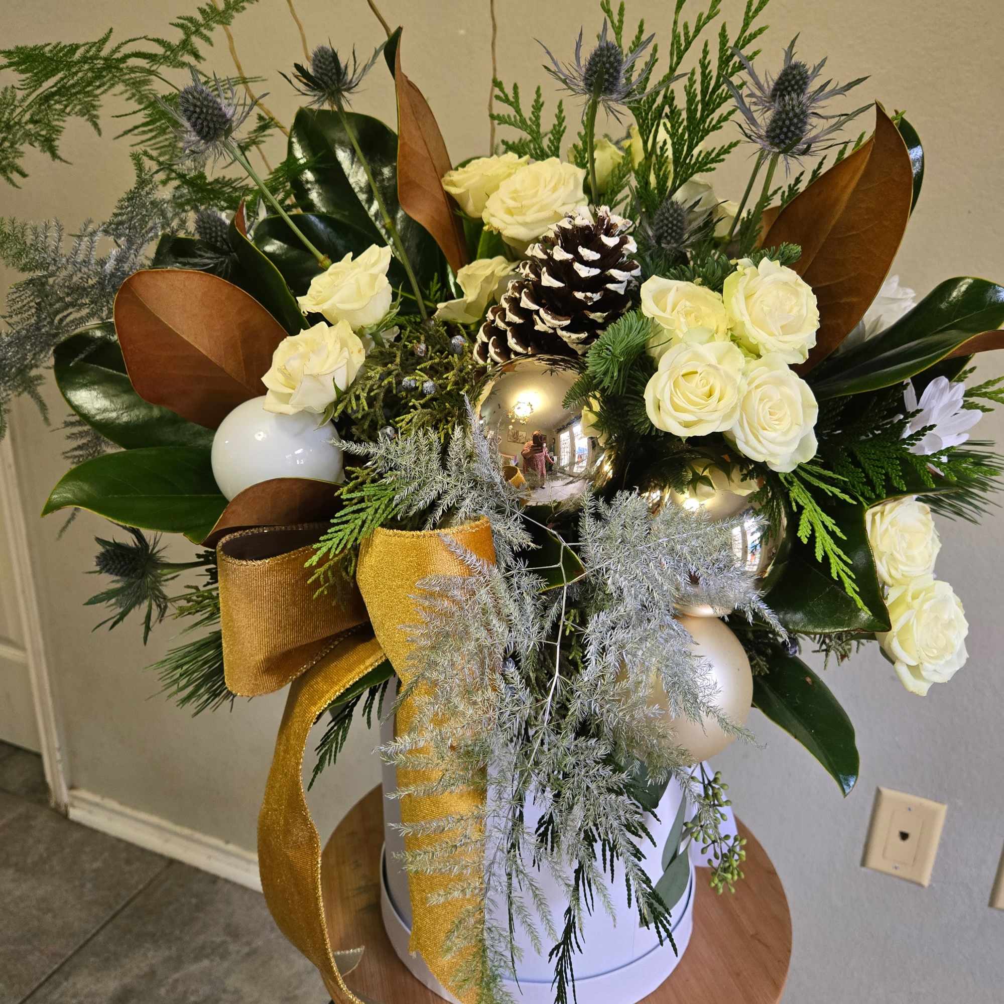 This is a beautiful white hat box arrangement with white roses, eucalyptus