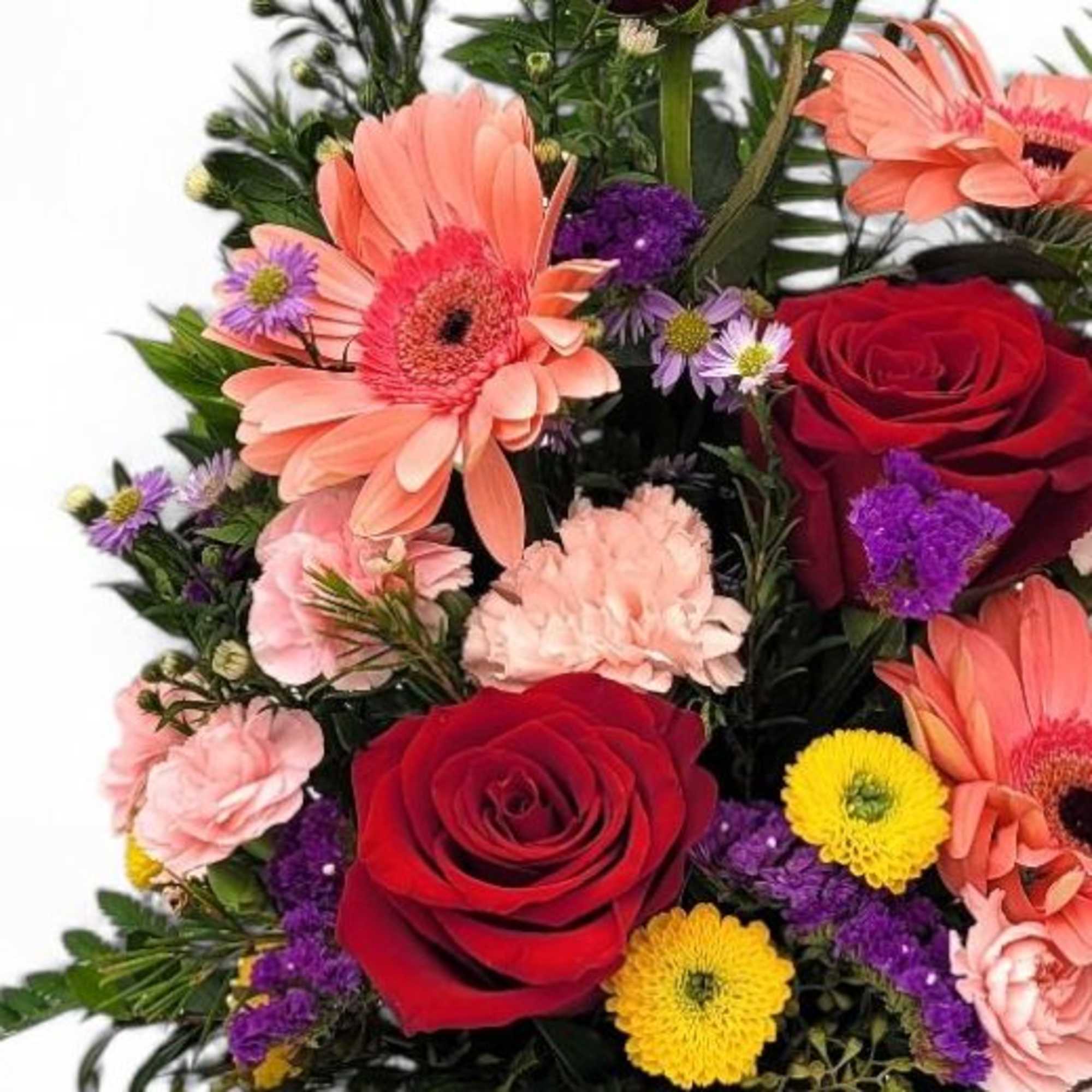 A beautiful arrangement of flowers in a rustic wooden cube overflowing with