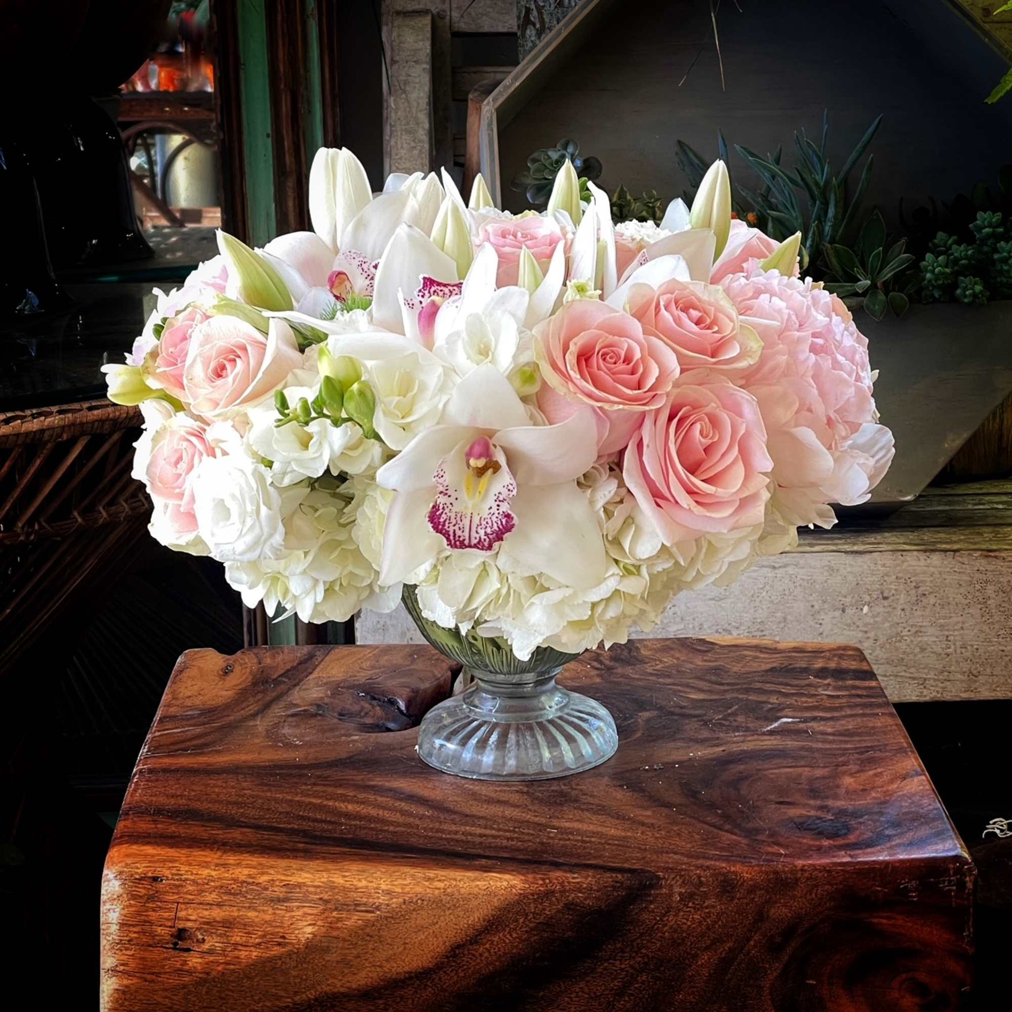 Premium Roses, Hydrangea, Tulips, Cymbidium Orchid...in center piece glass vase.