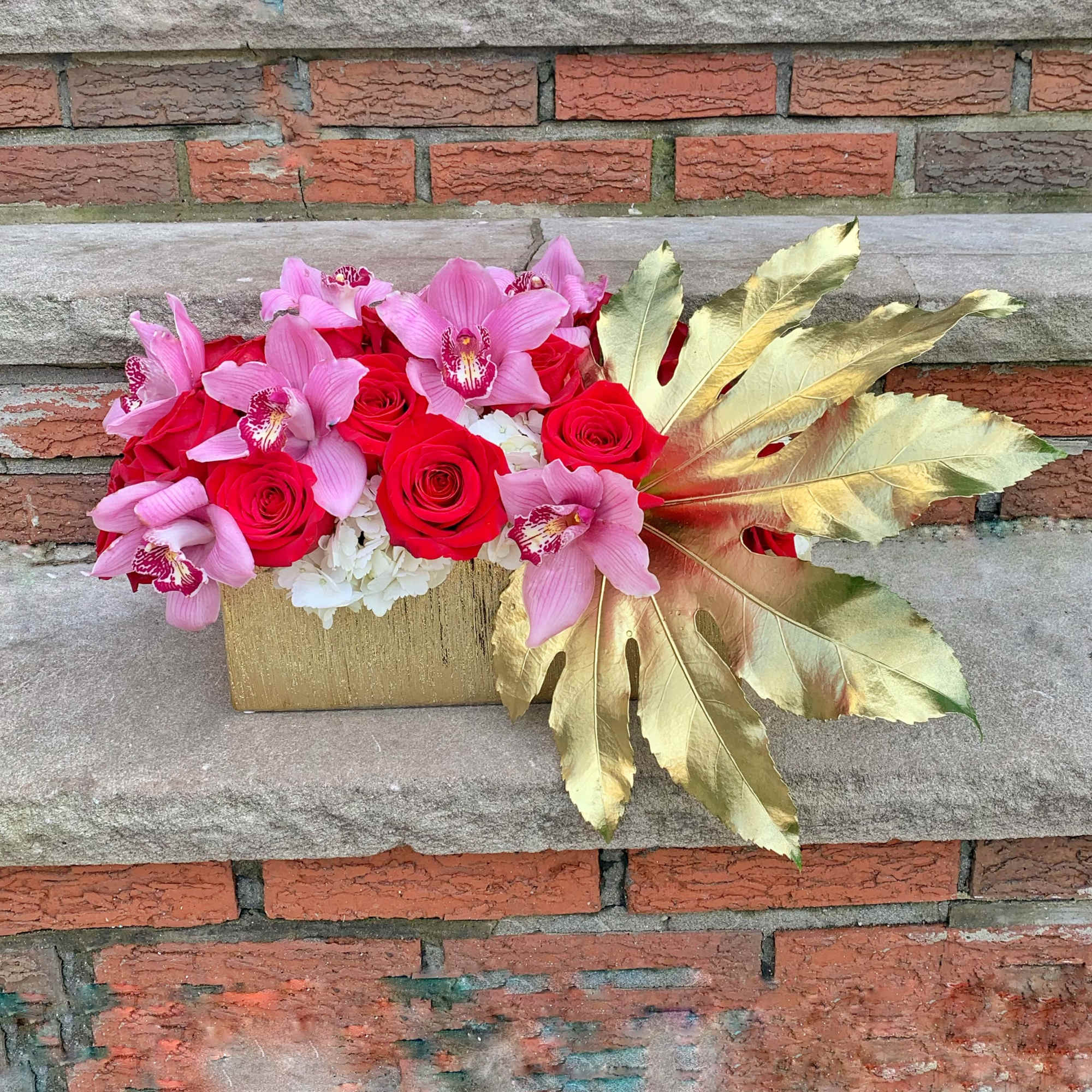 Looking to make a great impression? This luxe arrangement with Cymbidium Orchids