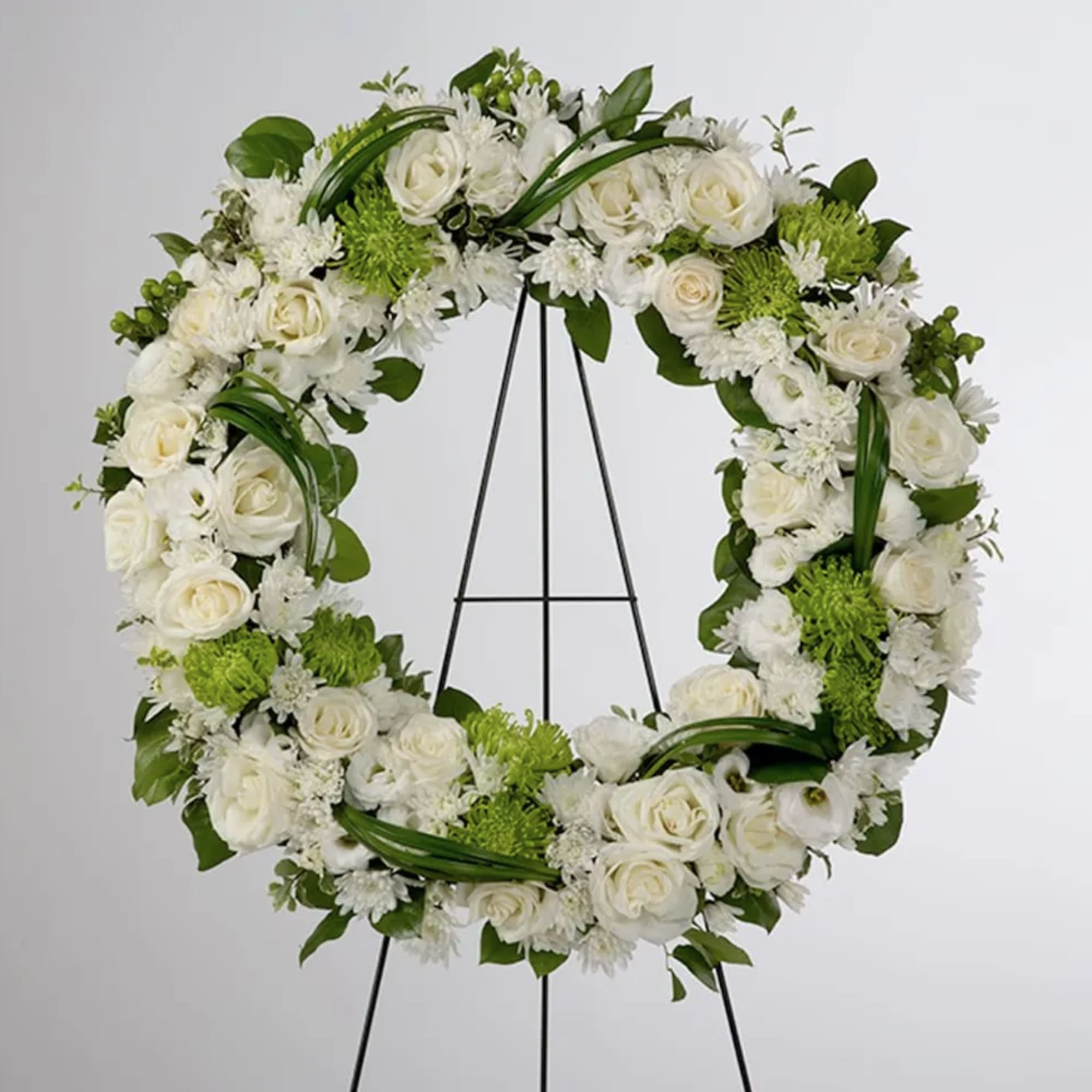 A beautiful white and green tribute wreath that calms, this easel arrangement