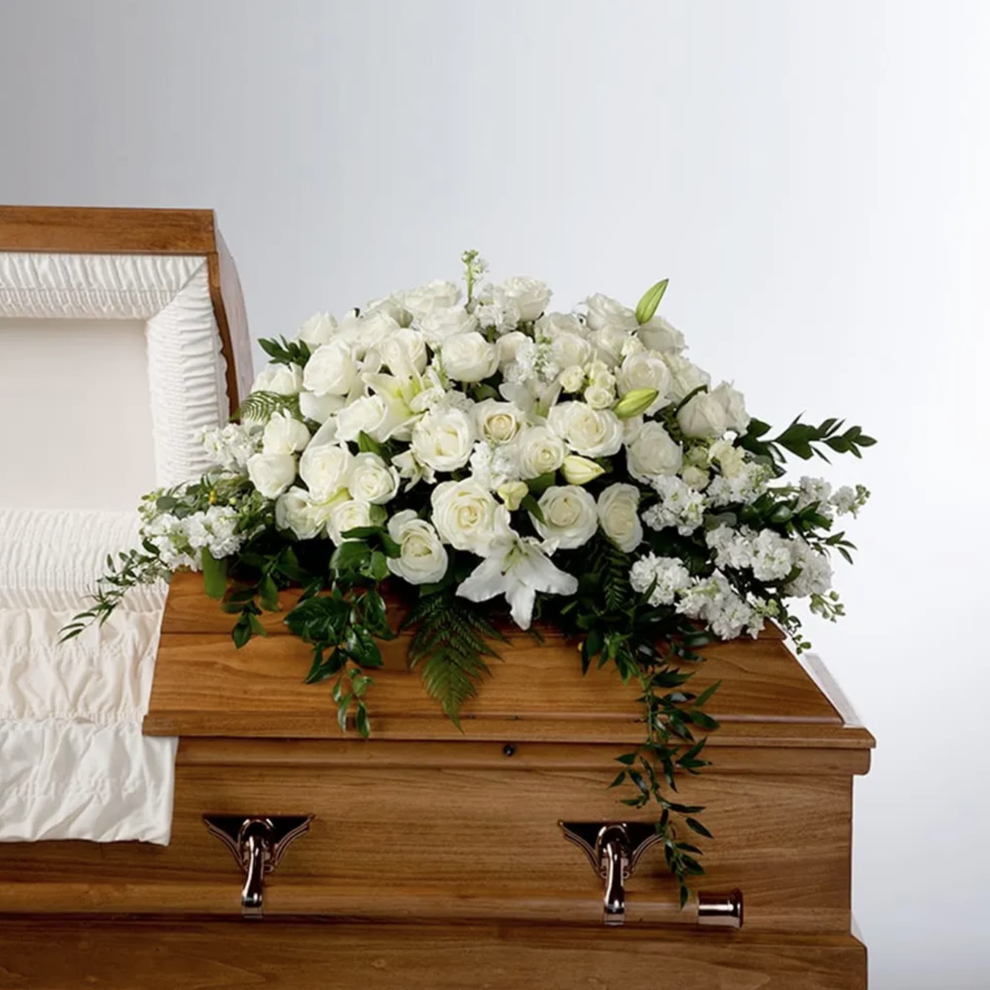An all white tribute, this half casket spray is pure in color