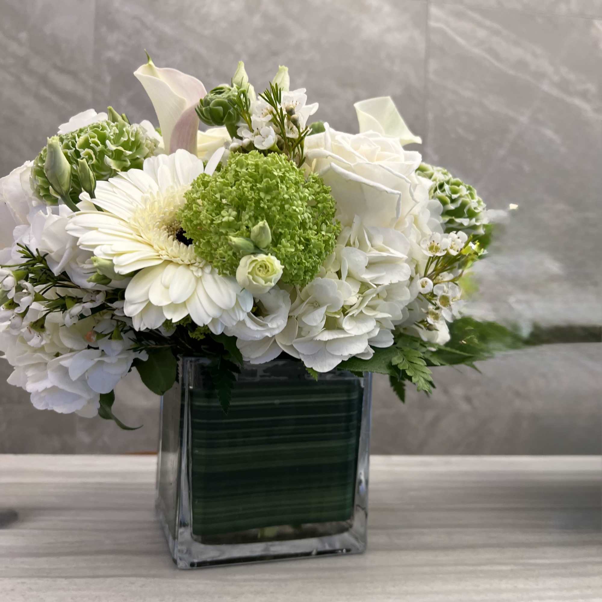 The overall palette of crisp whites and fresh greens evokes tranquility, purity