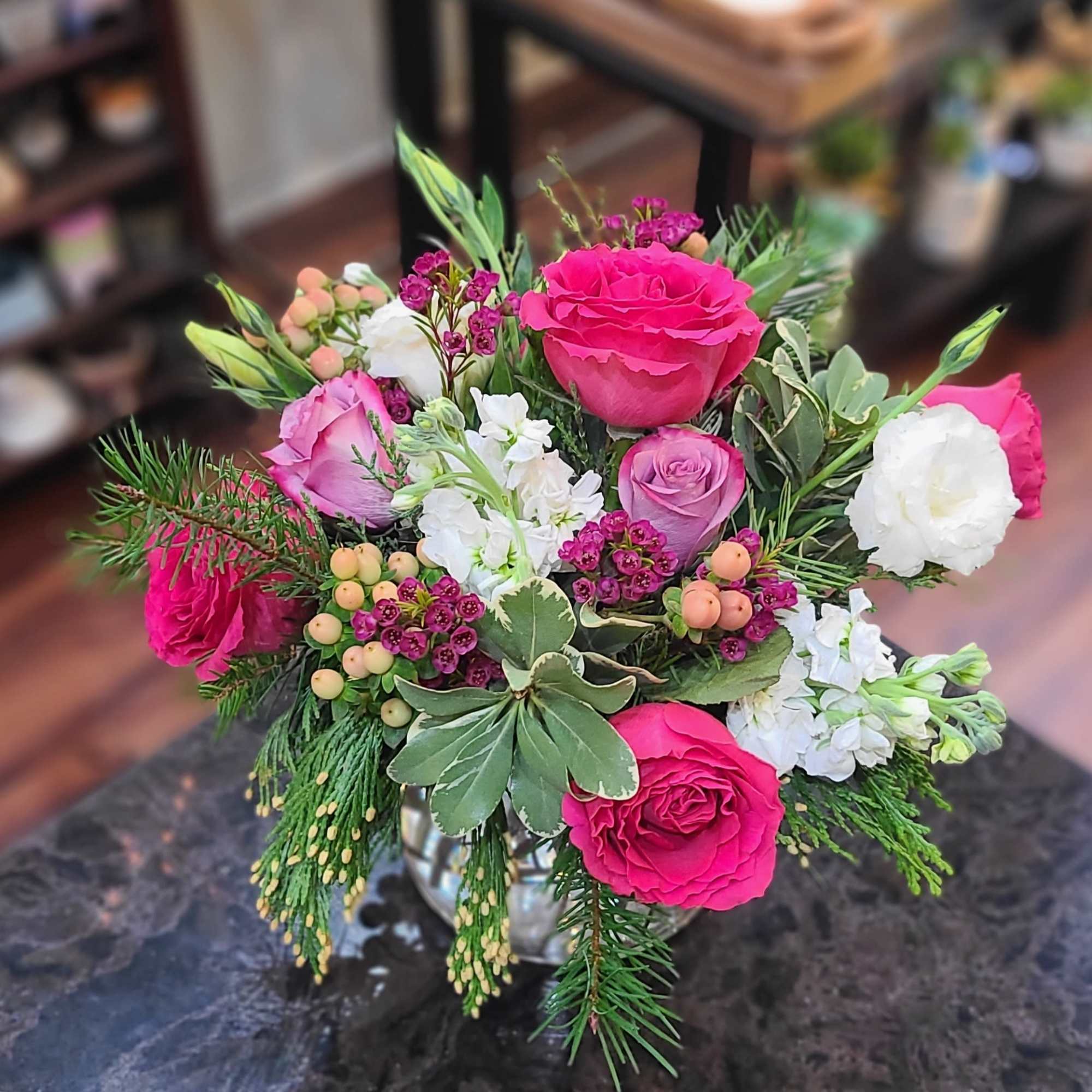 For the year-round pink lover, this arrangement combines fragrant seasonal greens and