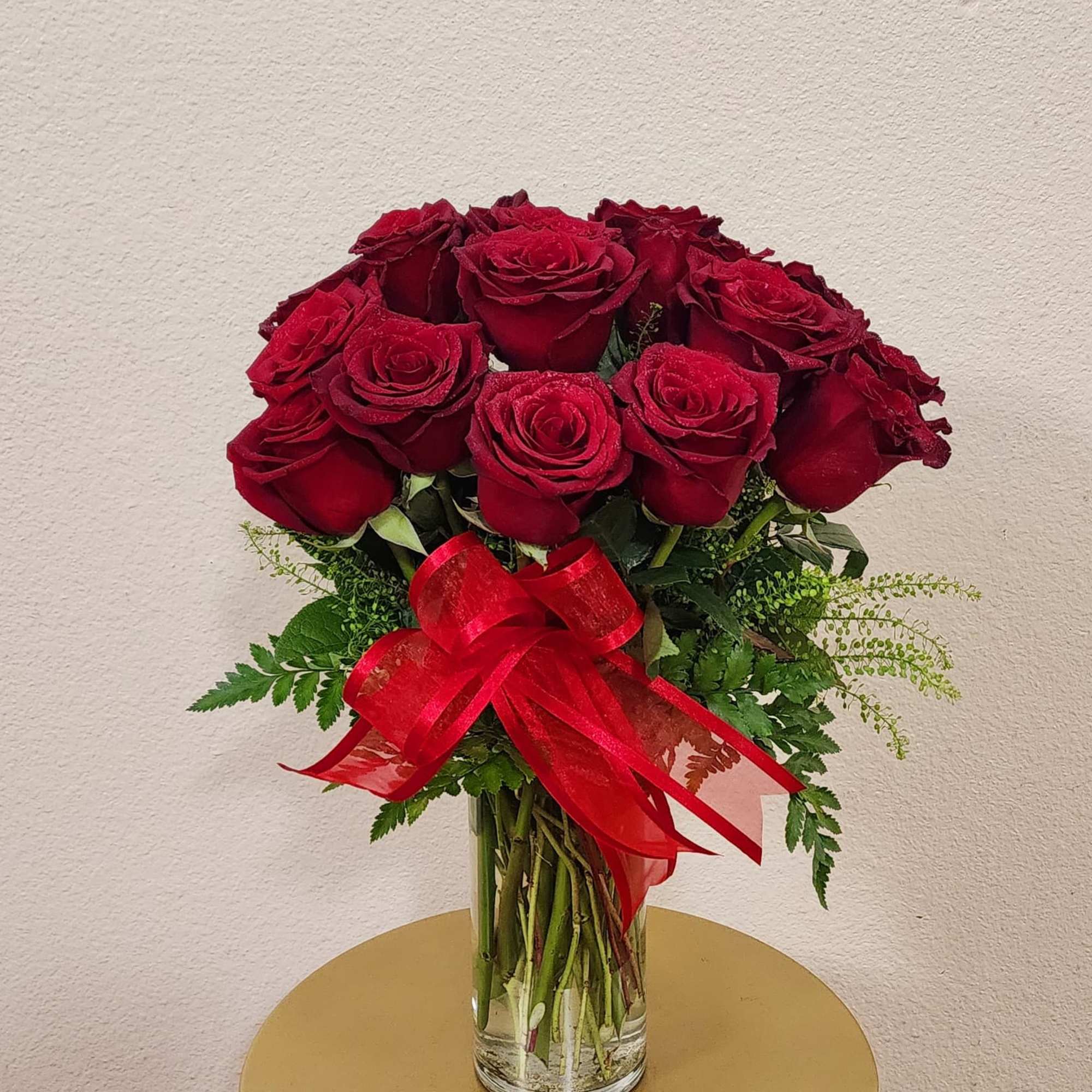 18 premium Ecuadorian roses with a bright red ribbon on it.