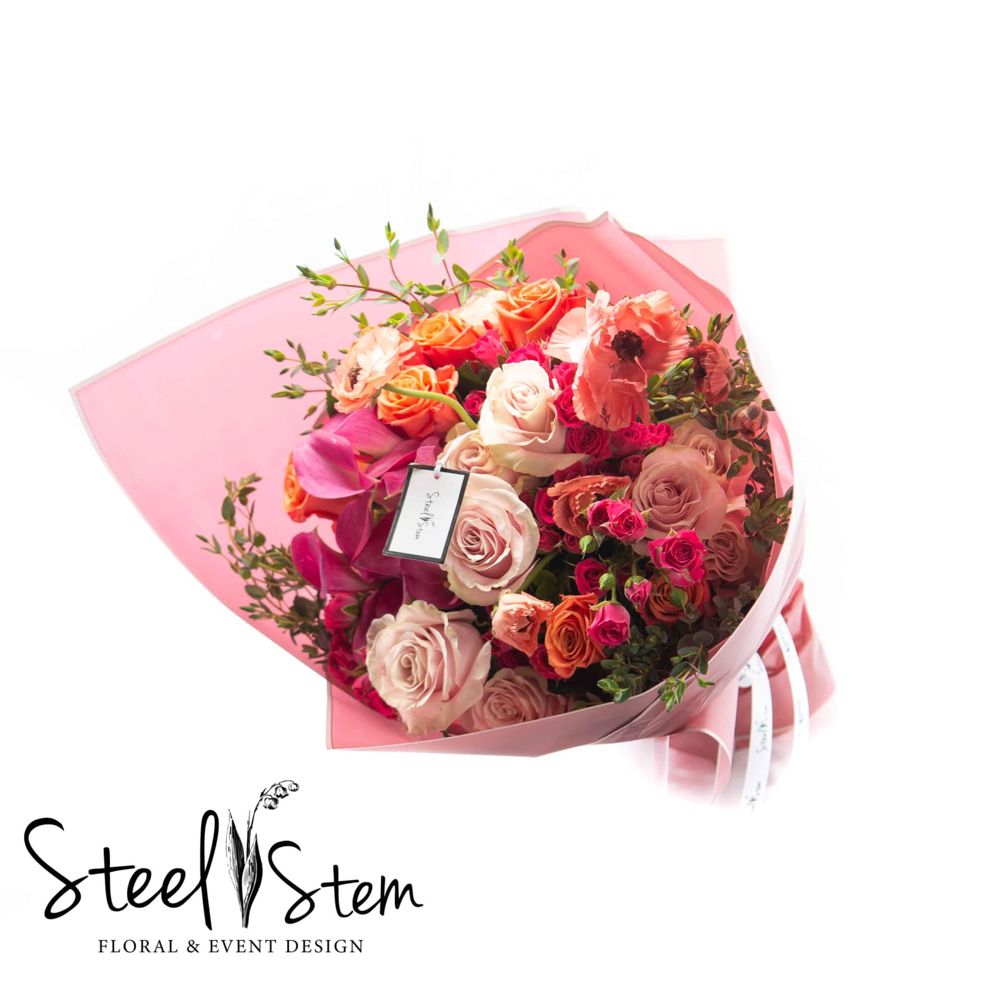 A vibrate mixture of seasonal pinks and oranges include shades of roses