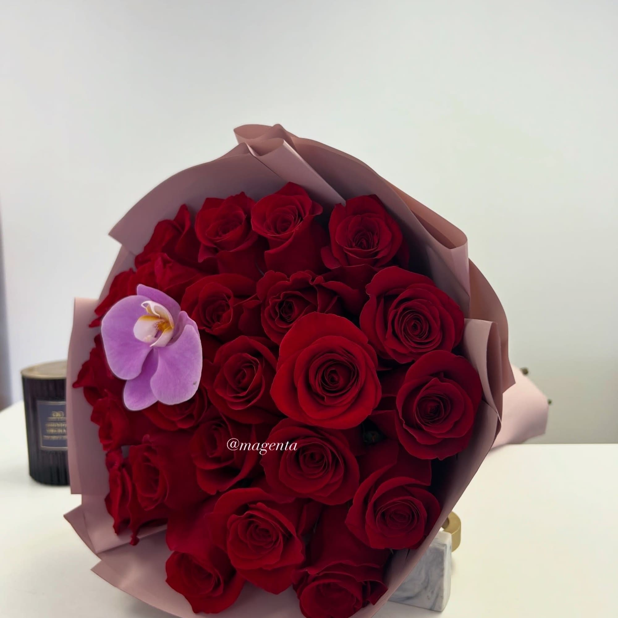 24ct red premium Ecuadorian roses with Orquid. Wrapped with waterproof paper in