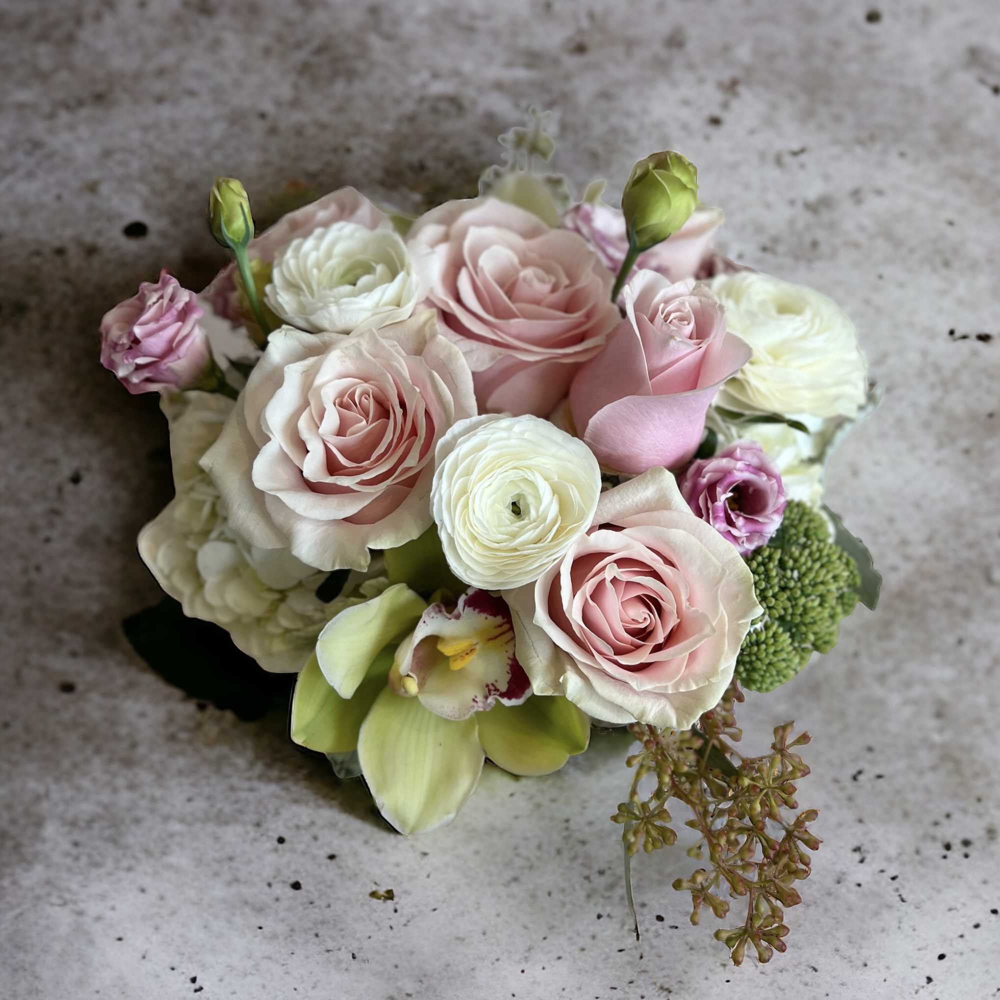 A sweet and tender selection of beautiful roses, ranunculus and other seasonal A sweet and tender selection of beautiful roses, ranunculus and other seasonal