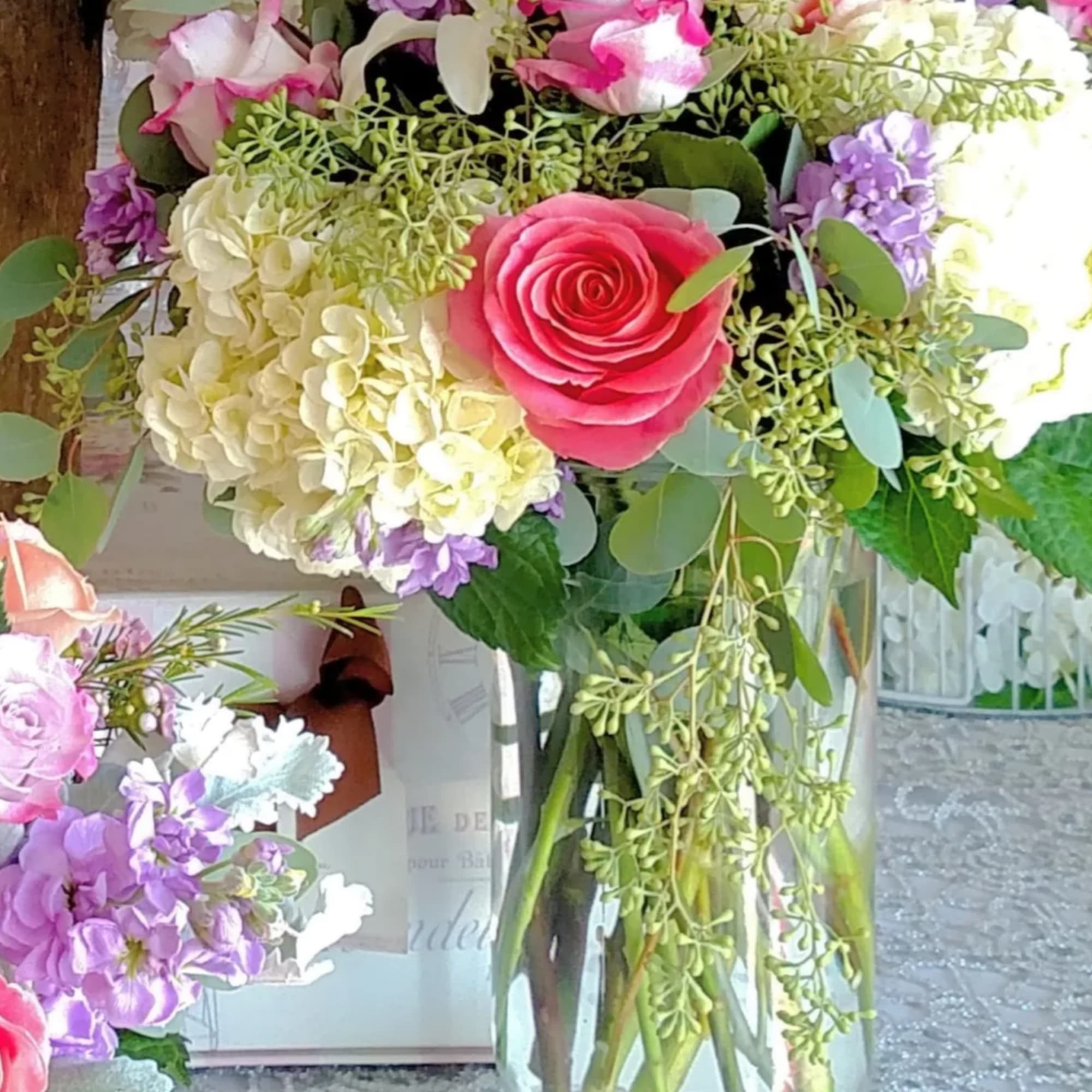 Hermosa or pink roses, lavender roses, lavender stock, hydrangea, wax and silver