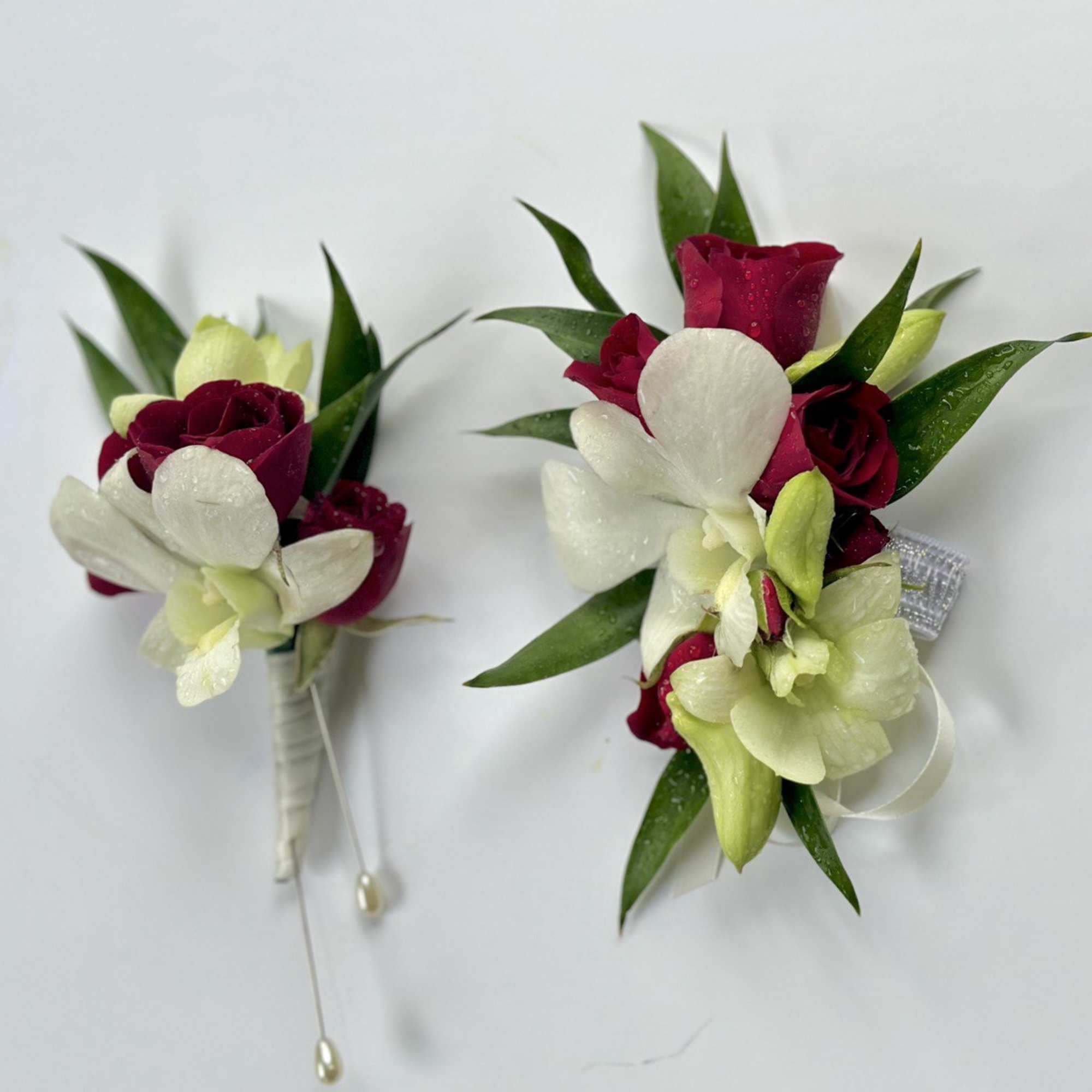 Set of Corsage and Boutonniere include white dendrobium orchids and red spray