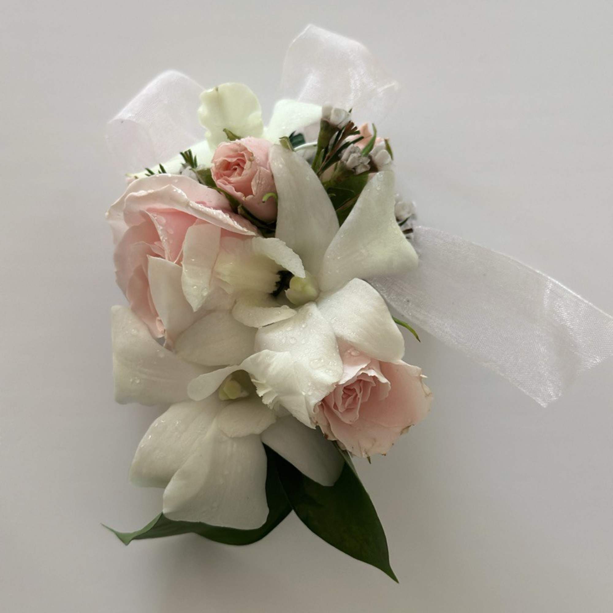 Set of Corsage and Boutonniere include white dendrobium orchids and pink spray
