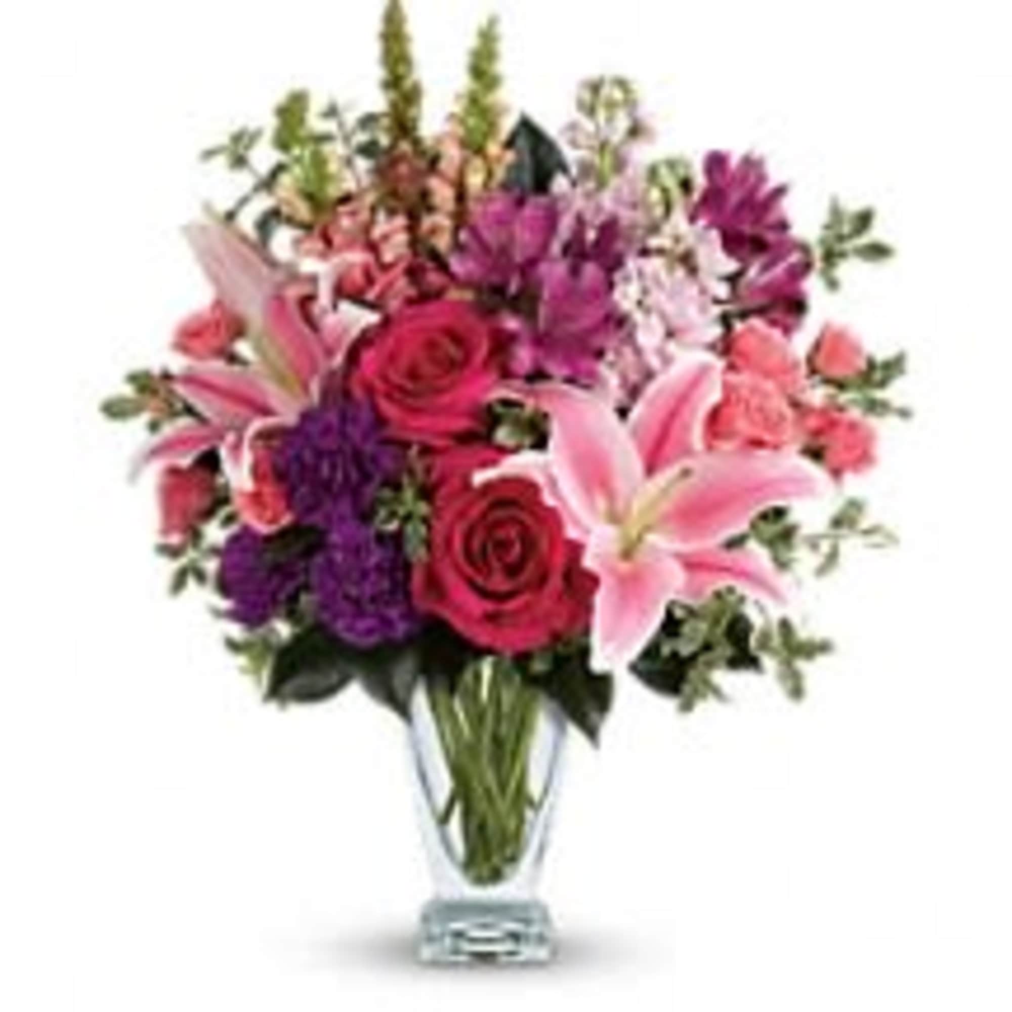 Hand-delivered in a shapely glass vase, this sumptuous arrangement of roses and