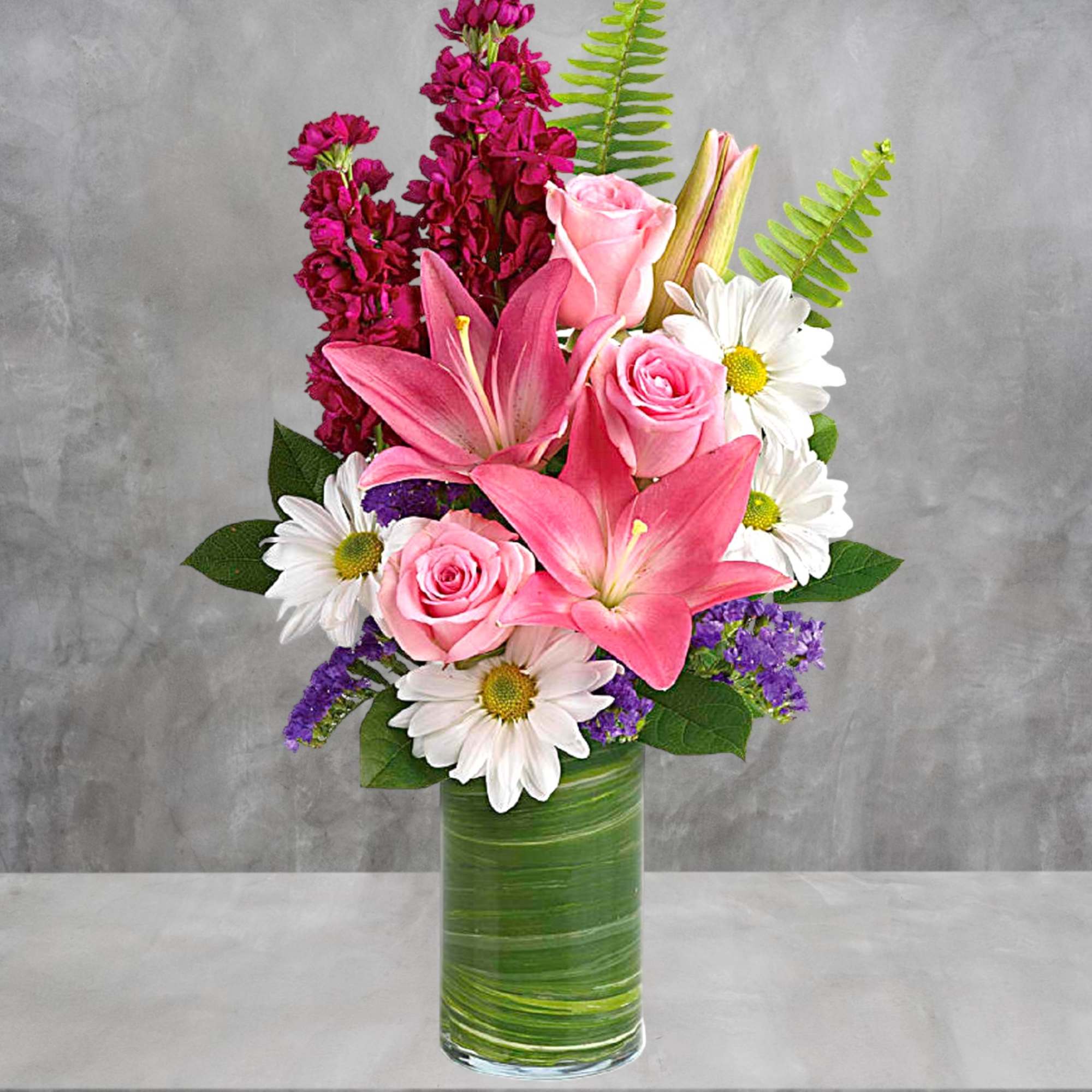 Full of whimsy, this playful bouquet of pink roses, white daisies, pink