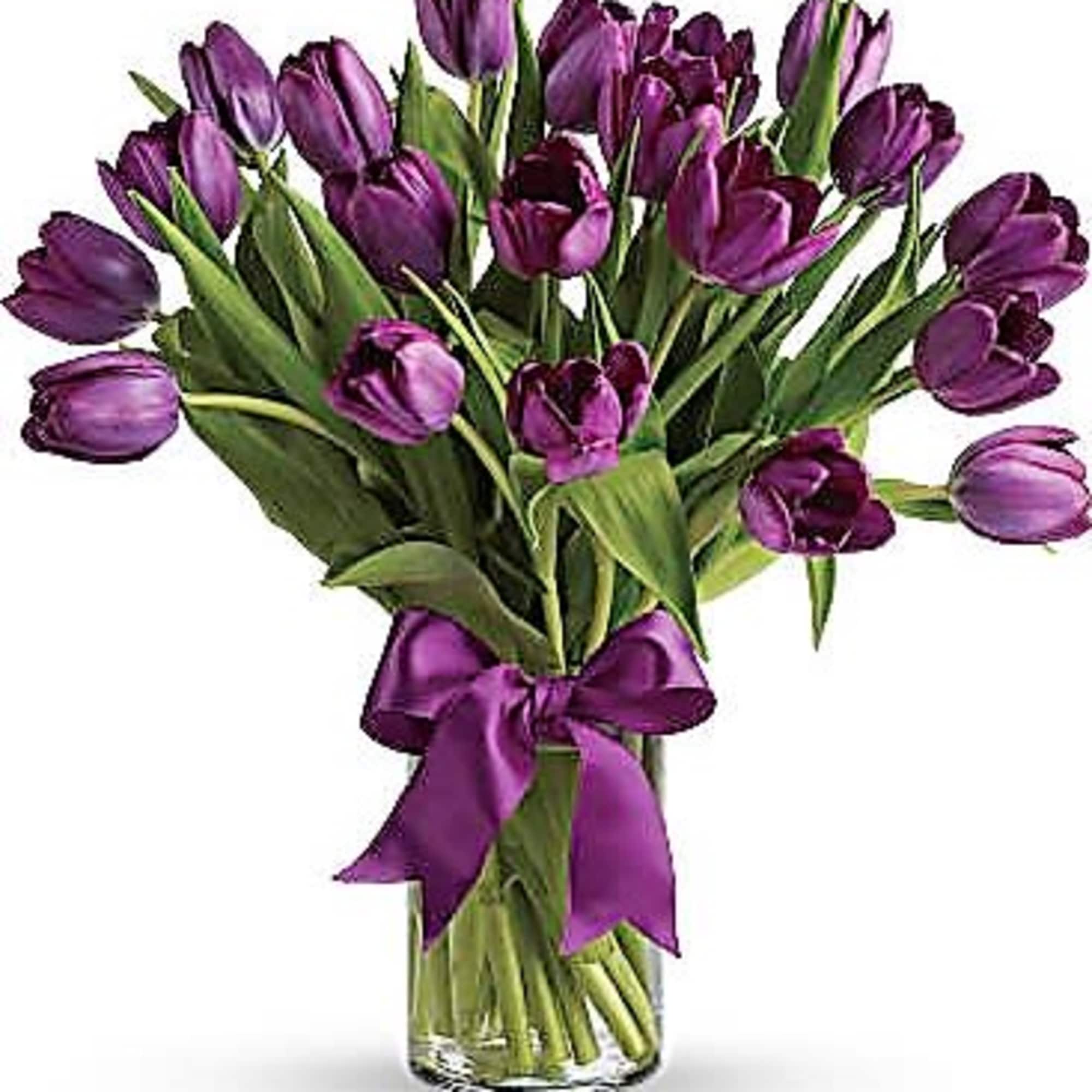 Purple tulips arranged in a vase with bow. Regular Price has 10