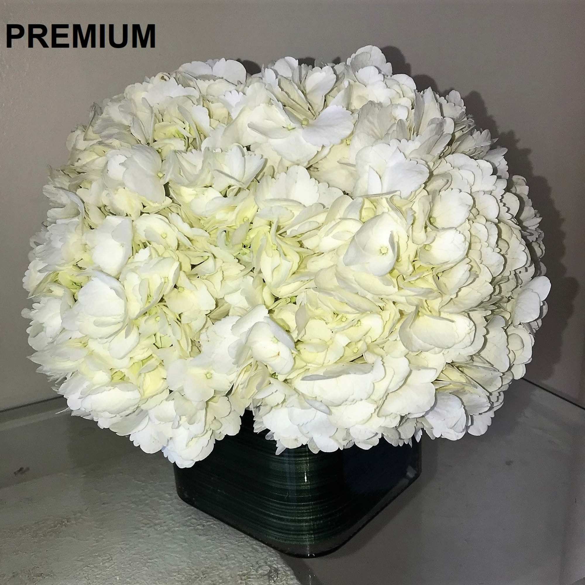 As shown: Hydrangeas arranged in a glass cube. 
** Deluxe: More hydrangeas.
**