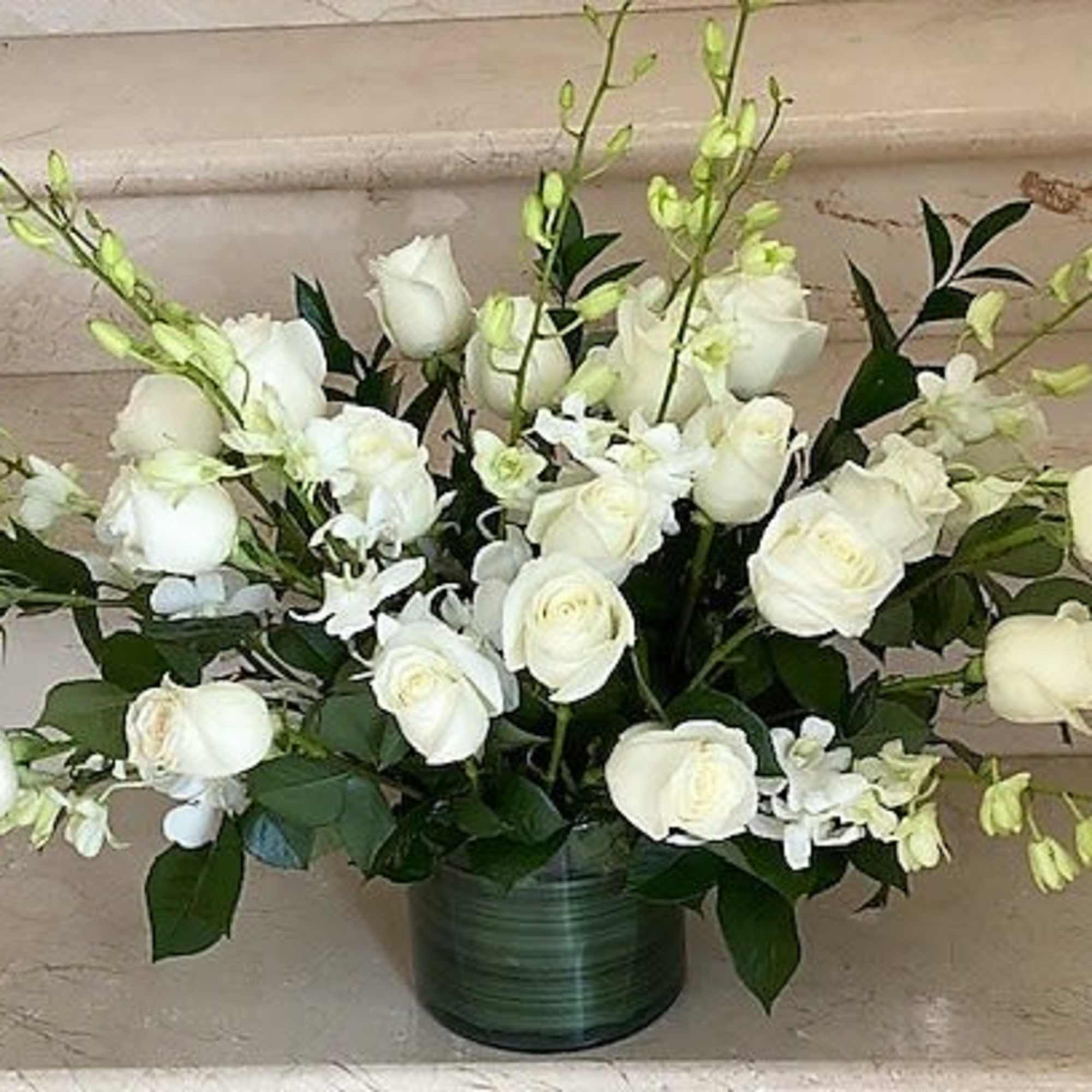 24 red and white roses and orchid stems throughout, arranged in a