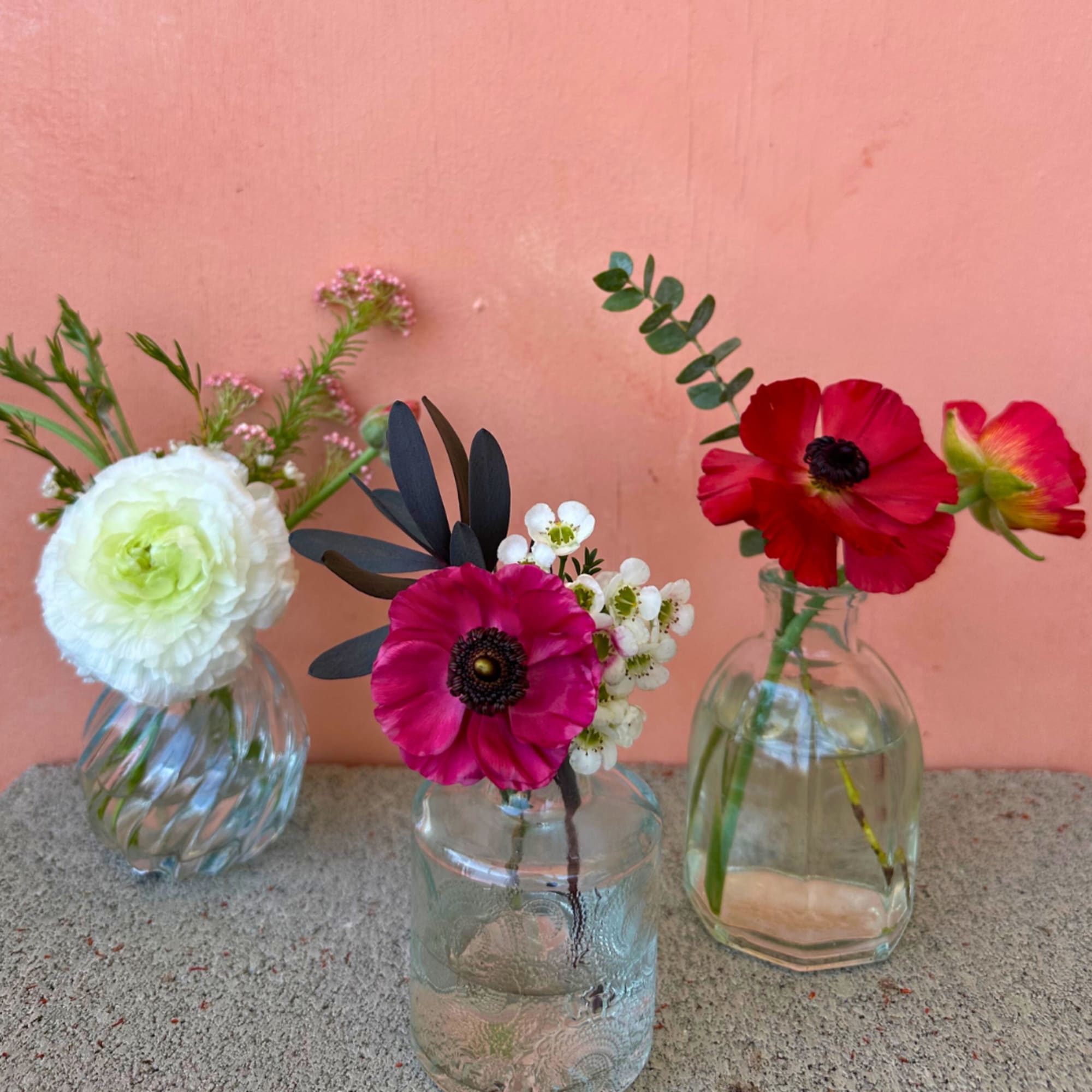 Petite arrangements with purpose. A selection of blooms, greens, and accents in