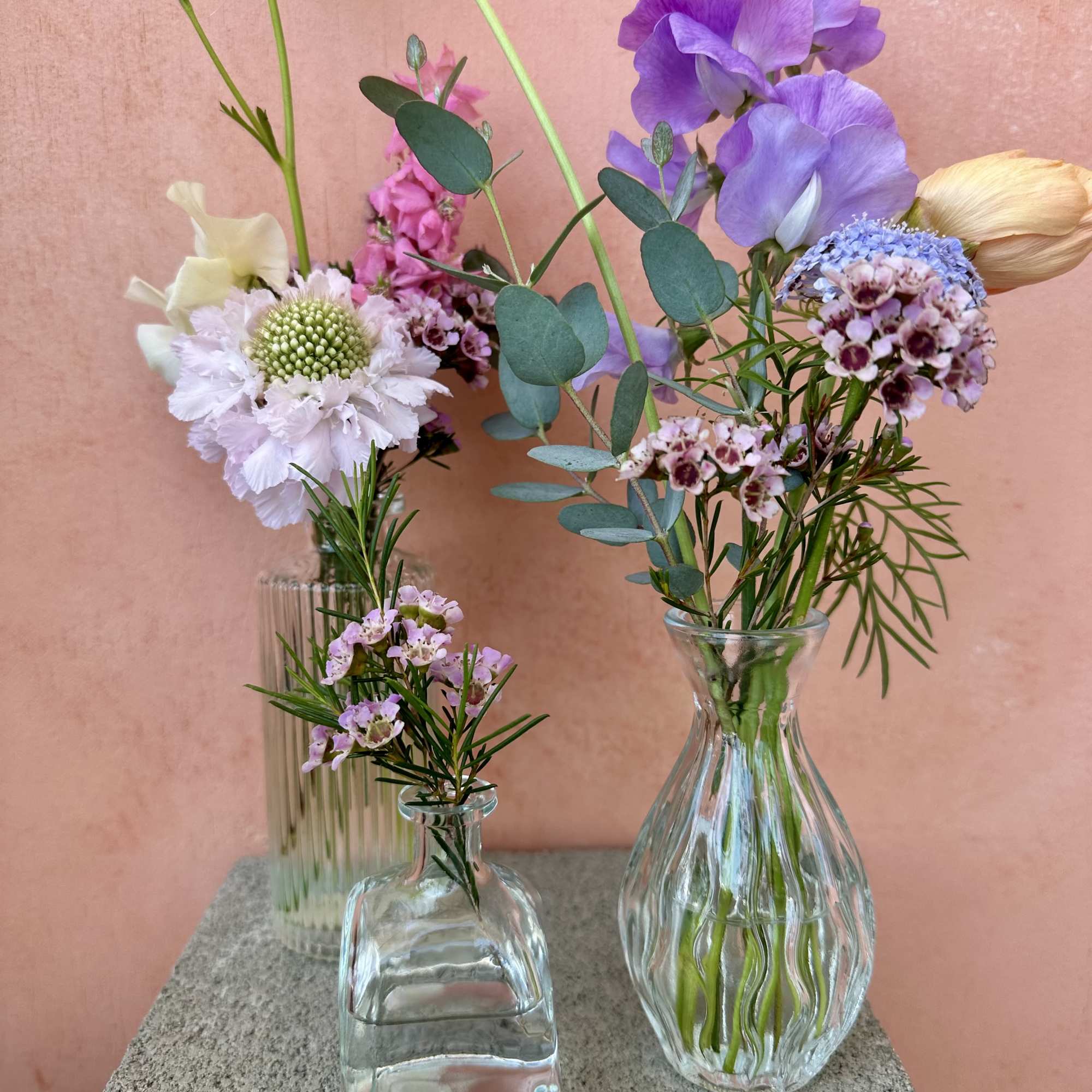 Petite arrangements with purpose. A selection of blooms, greens, and accents in