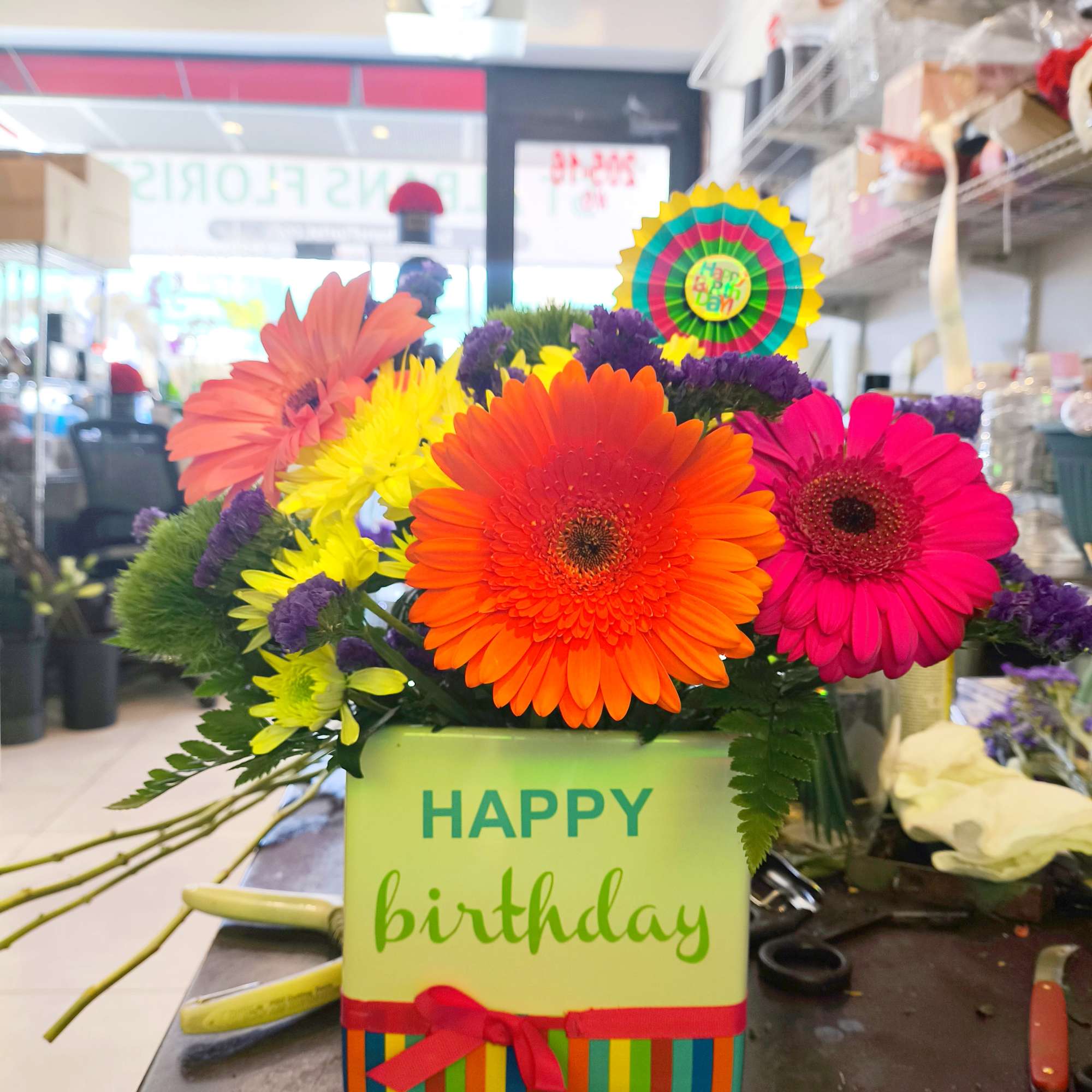 We use a beautiful white ceramic happy birthday container and add beautiful