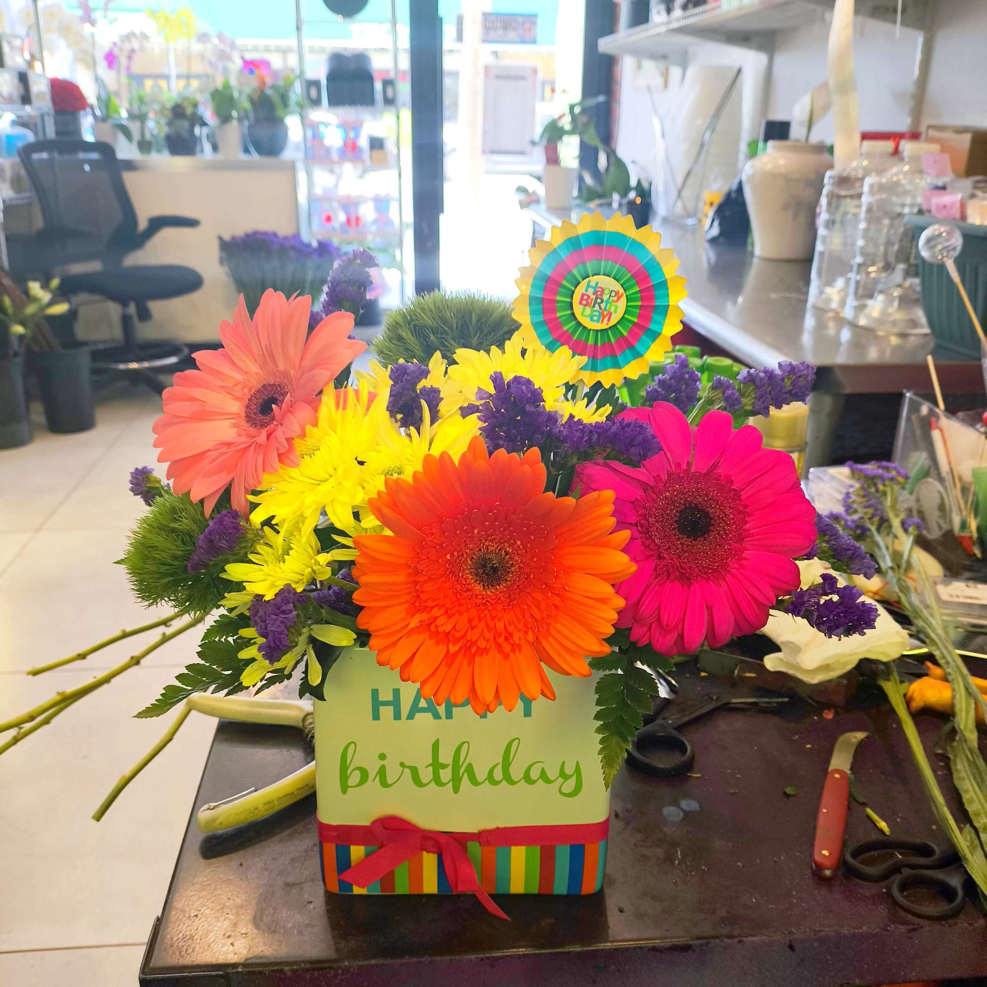 We use a beautiful white ceramic happy birthday container and add beautiful