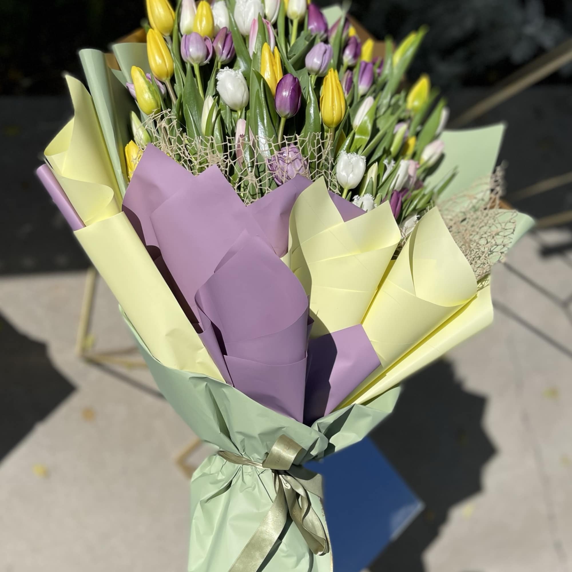 Mixed tulip bouquet wrapped in colorful paper.  Mixed tulip bouquet wrapped in colorful paper.