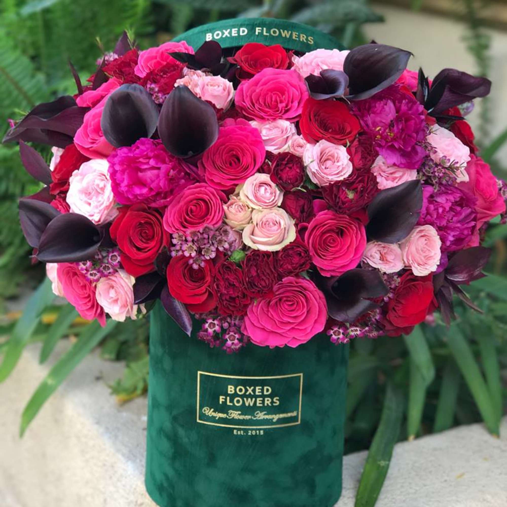 A gorgeous mix of hot pink, red and blush roses mixed with A gorgeous mix of hot pink, red and blush roses mixed with