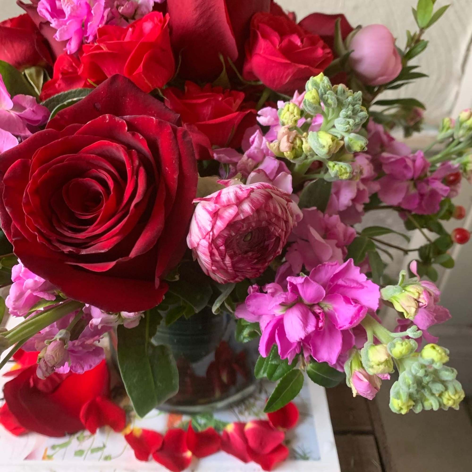 Win any heart with this signature arrangement of lush red roses, pink