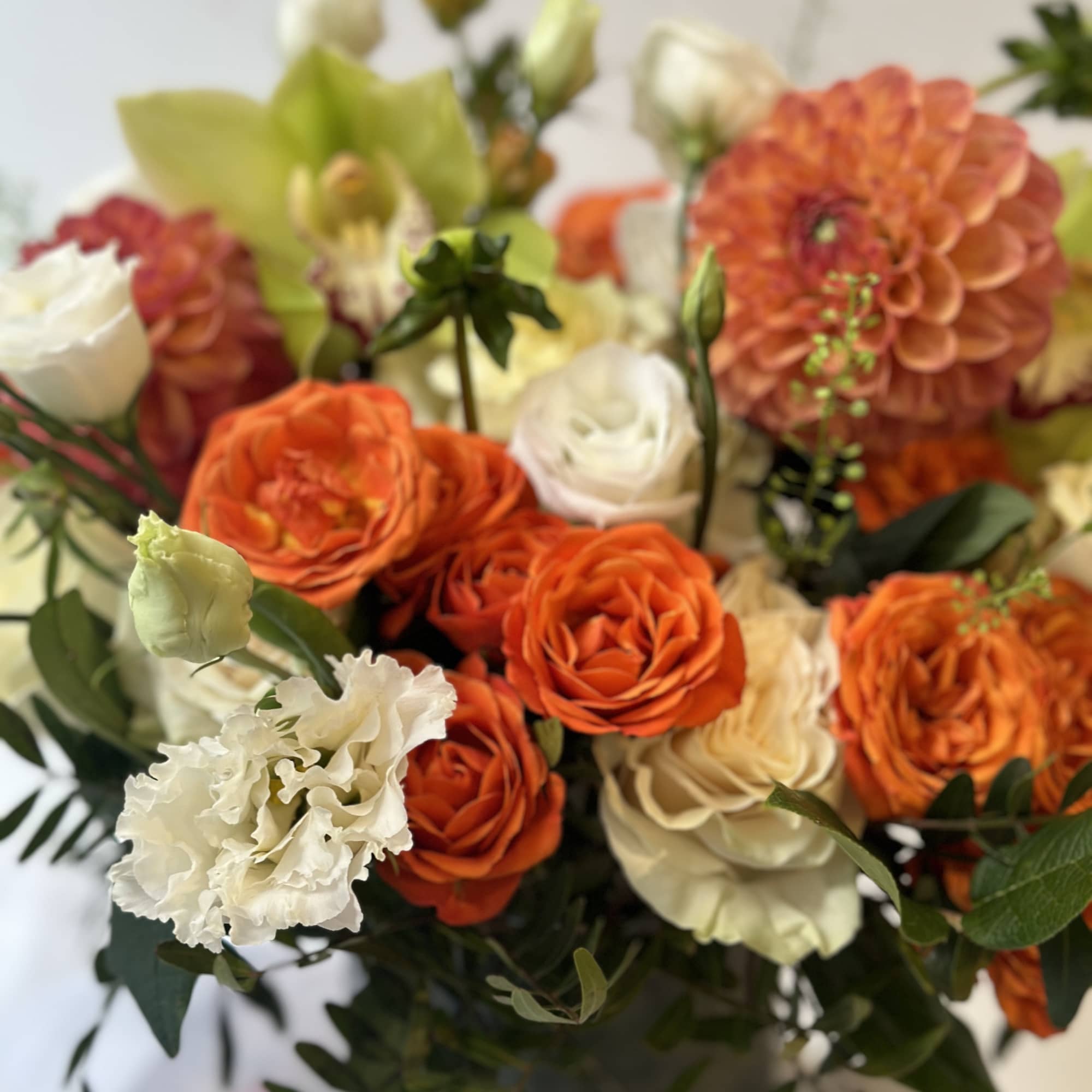 Summer crush! Orange roses, white lisianthus and dahlias with fresh summer greenery.