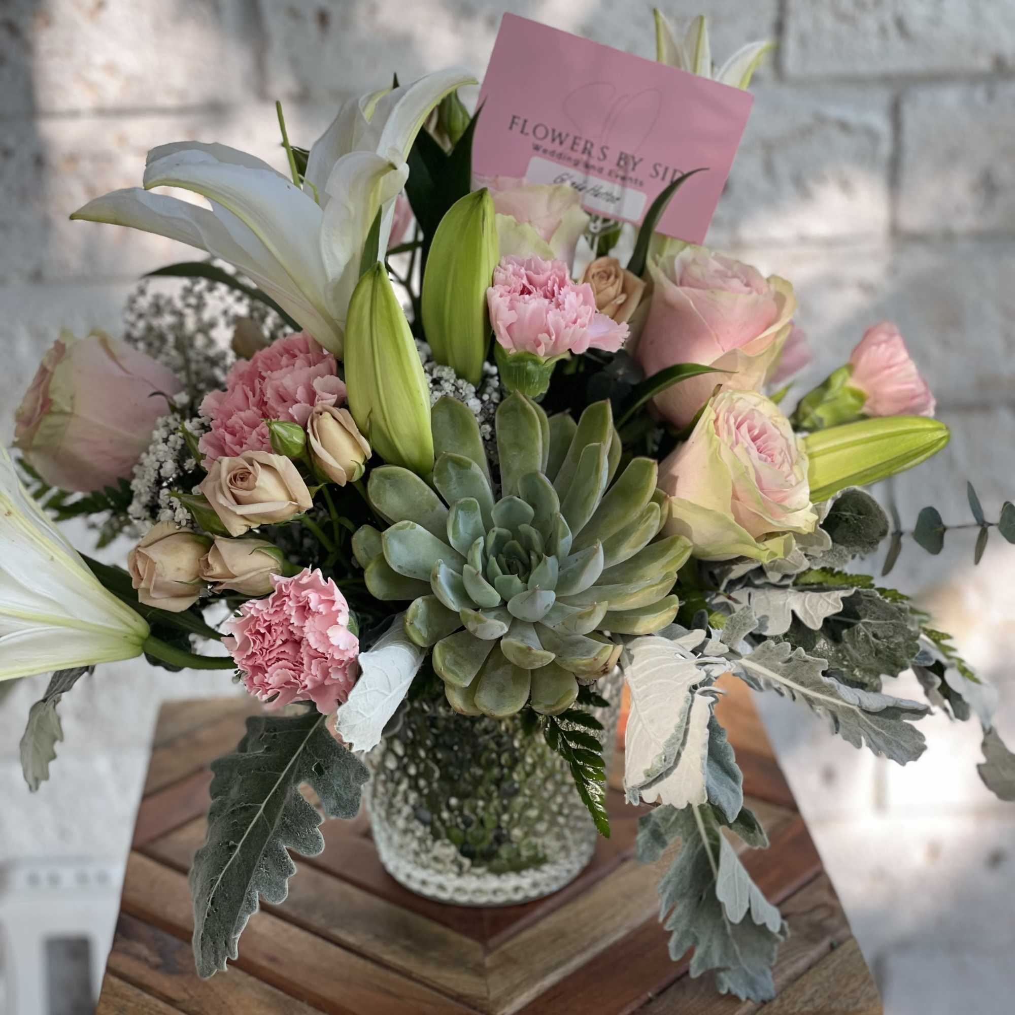 Lovely combination of pinks and whites blooms, seasonal greenery and high quality