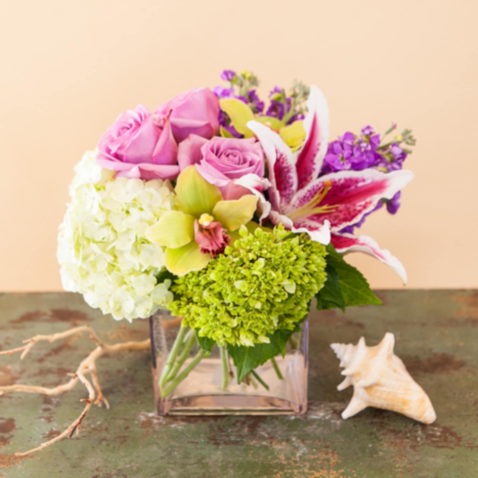 A stunning, pastel compact arrangement of hydrangea, roses, lilies, orchids and other A stunning, pastel compact arrangement of hydrangea, roses, lilies, orchids and other