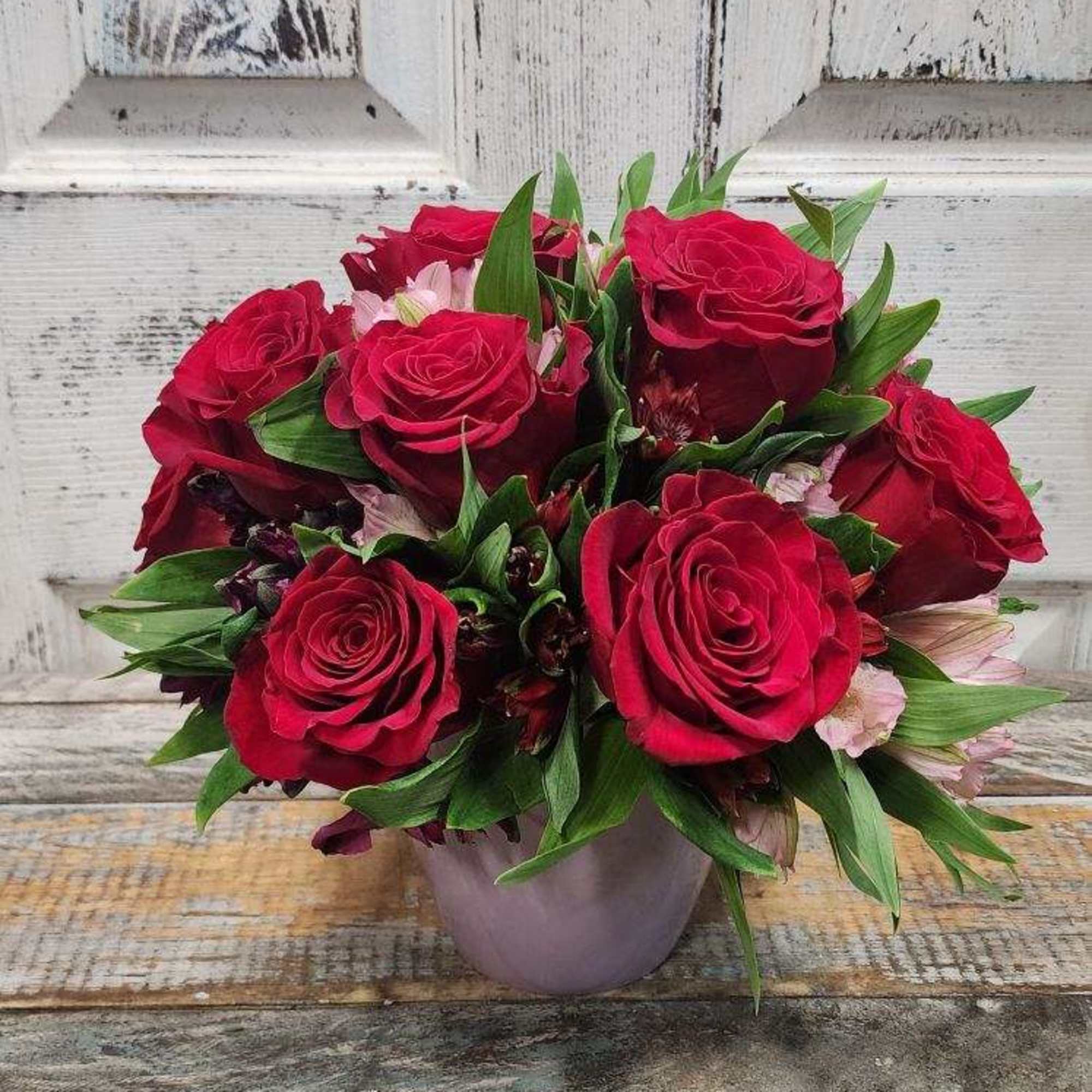 12 beautiful red roses filled together with a colorful verity of alstroemerias